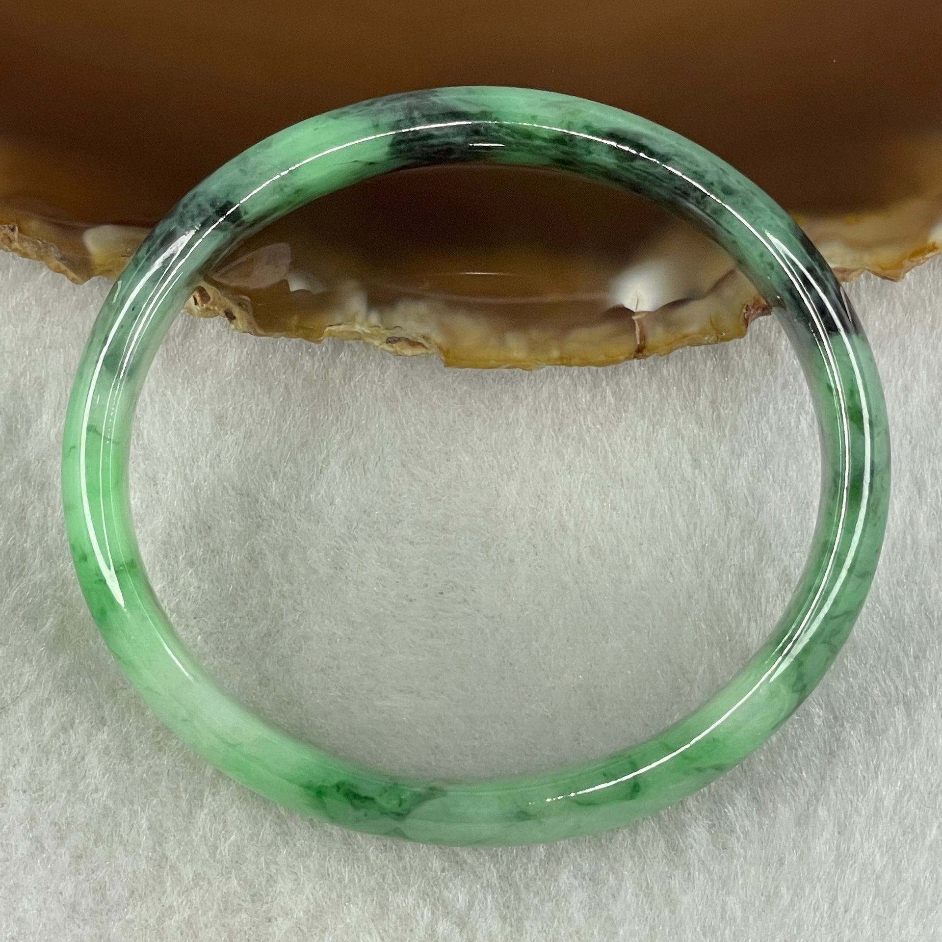 Type A Natural Old Mine Spicy Green with Dark Green Piao Hua Flora Jadeite Oval Bangle 26.28g 131.60cts Inner Diameter 52.55mm 46.90 by 5.40mm with NGI Cert 63804952 (Very Very Slight Internal Lines) - Huangs Jadeite and Jewelry Pte Ltd