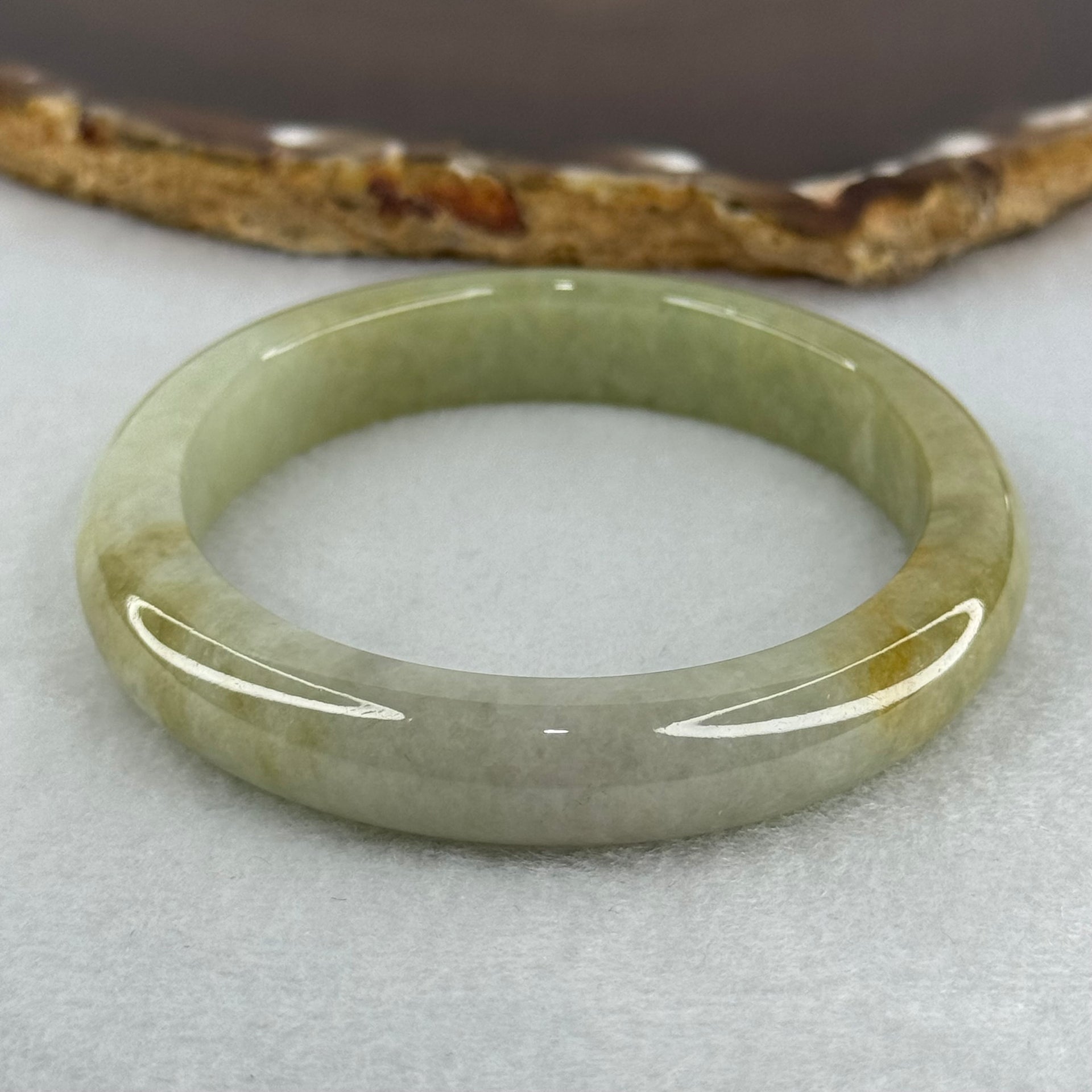 Type A Yellowish Green Lavender Jadeite Oval Bangle Internal Diameter 58.5mm 67.31g 10.7 by 8.1mm (Very Slight Fine Internal Line) - Huangs Jadeite and Jewelry Pte Ltd