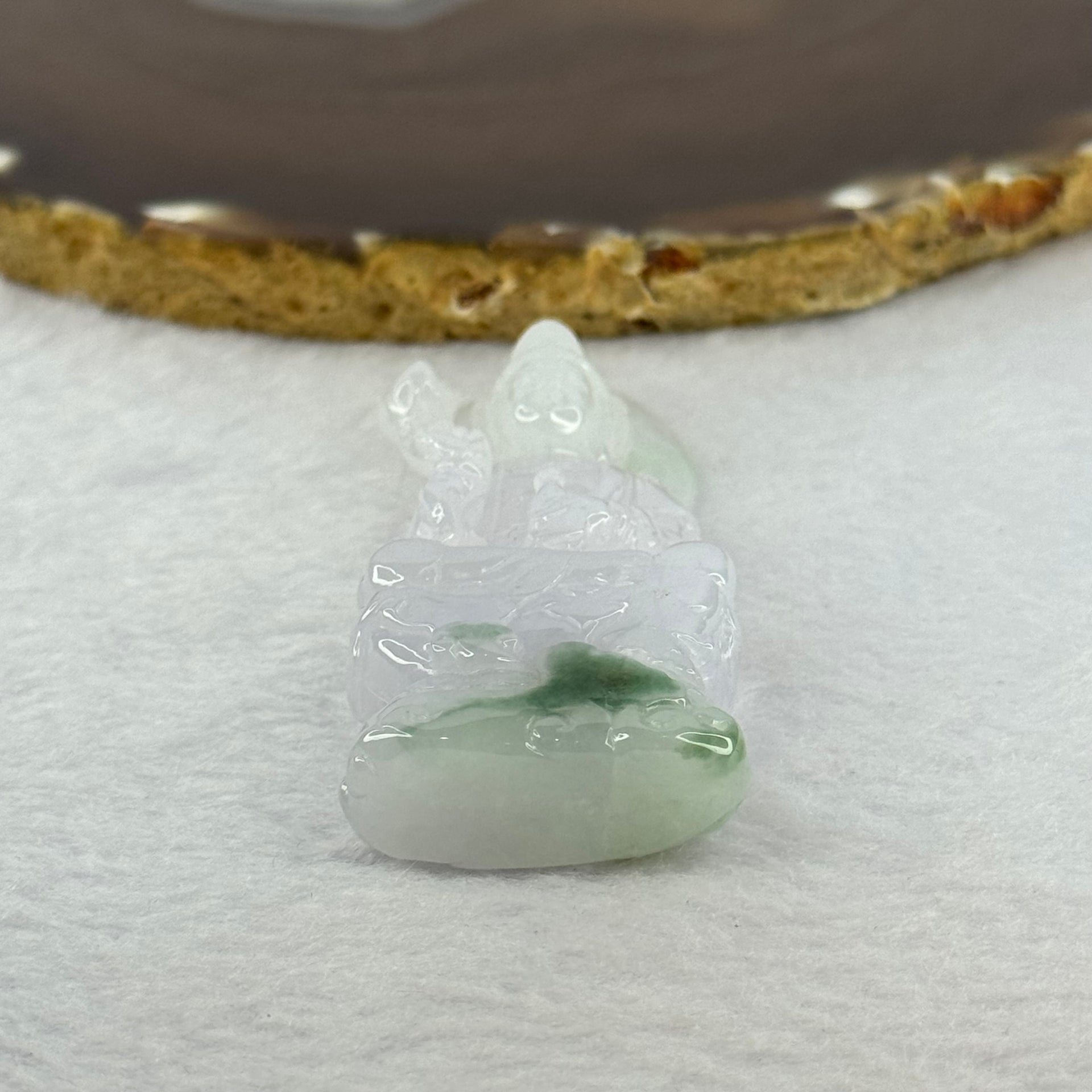 Type A Light Lavender with Green Patches Jadeite Guan Yin Pendent with Wooden Stand 111.55g  111.8 by 58.7 by 46.6mm - Huangs Jadeite and Jewelry Pte Ltd