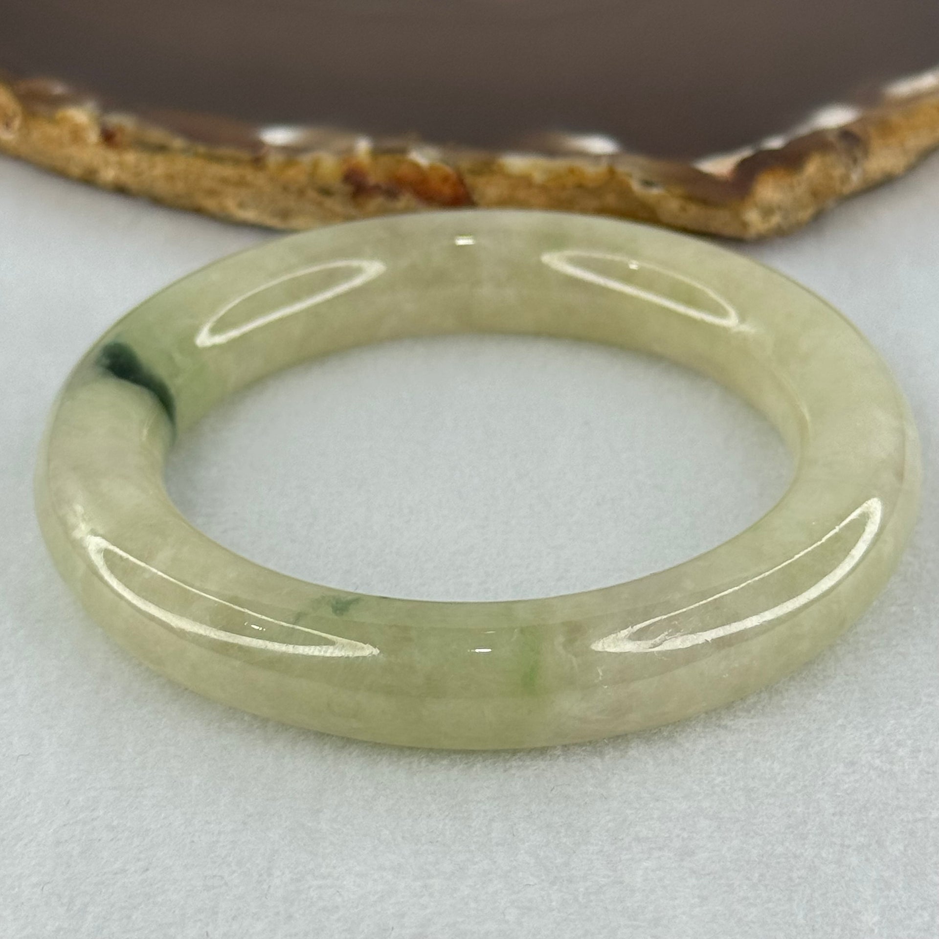 Type A Translucent Semi Icy Light Yellowish Green with Moss Green Patch Jadeite Bangle Internal Diameter 55.3mm 76.40g 12.3 by 11.6mm (Very Slight External Rough) - Huangs Jadeite and Jewelry Pte Ltd