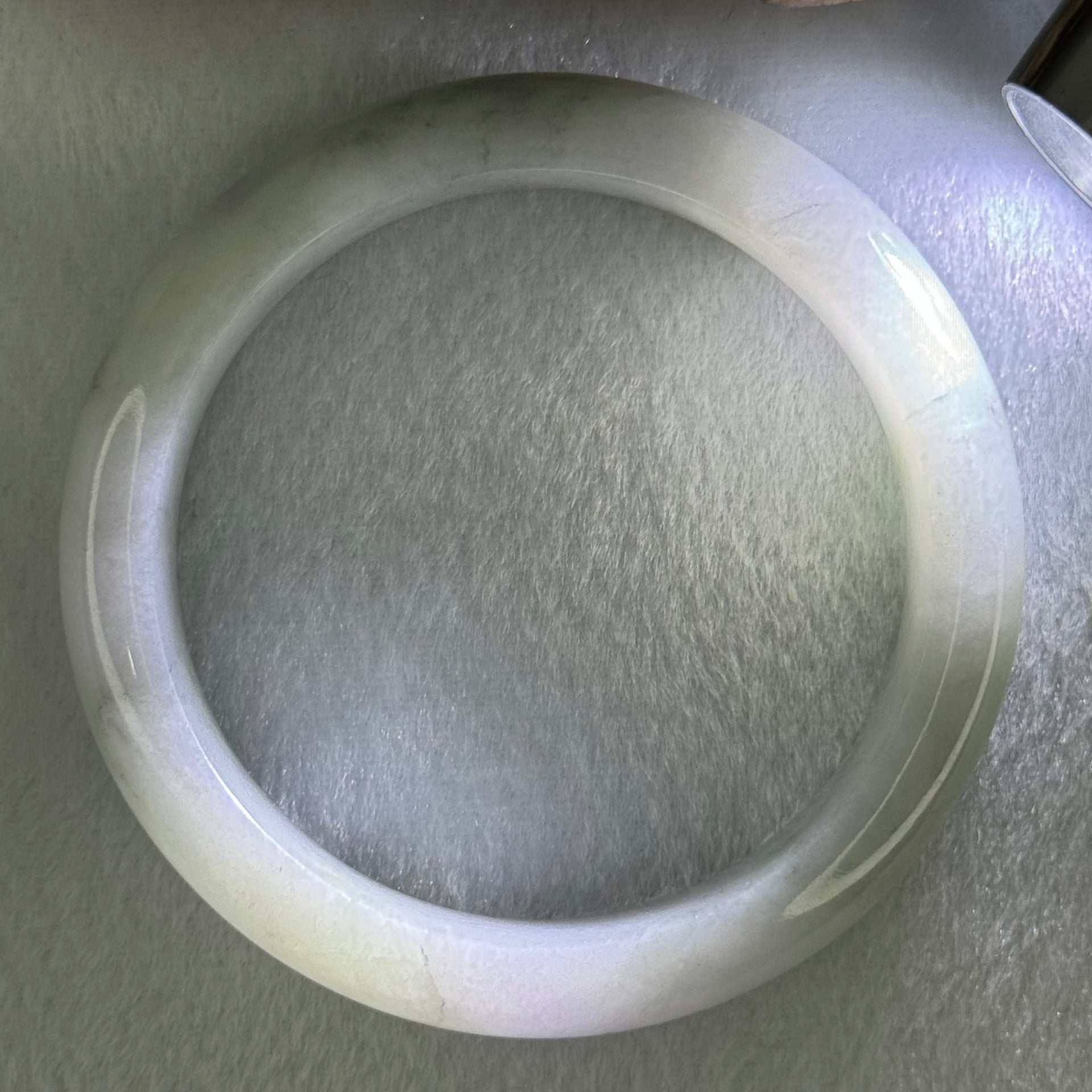 Type A Translucent Faint Blueish Green with Patches of Light Grey and Faint Lavender Jadeite Bangle Internal Diameter 56.95mm 344.09cts 69.22g 14.6 by 8.9mm With NGI Cert No 32886054 (Very Slight Internal Line) - Huangs Jadeite and Jewelry Pte Ltd