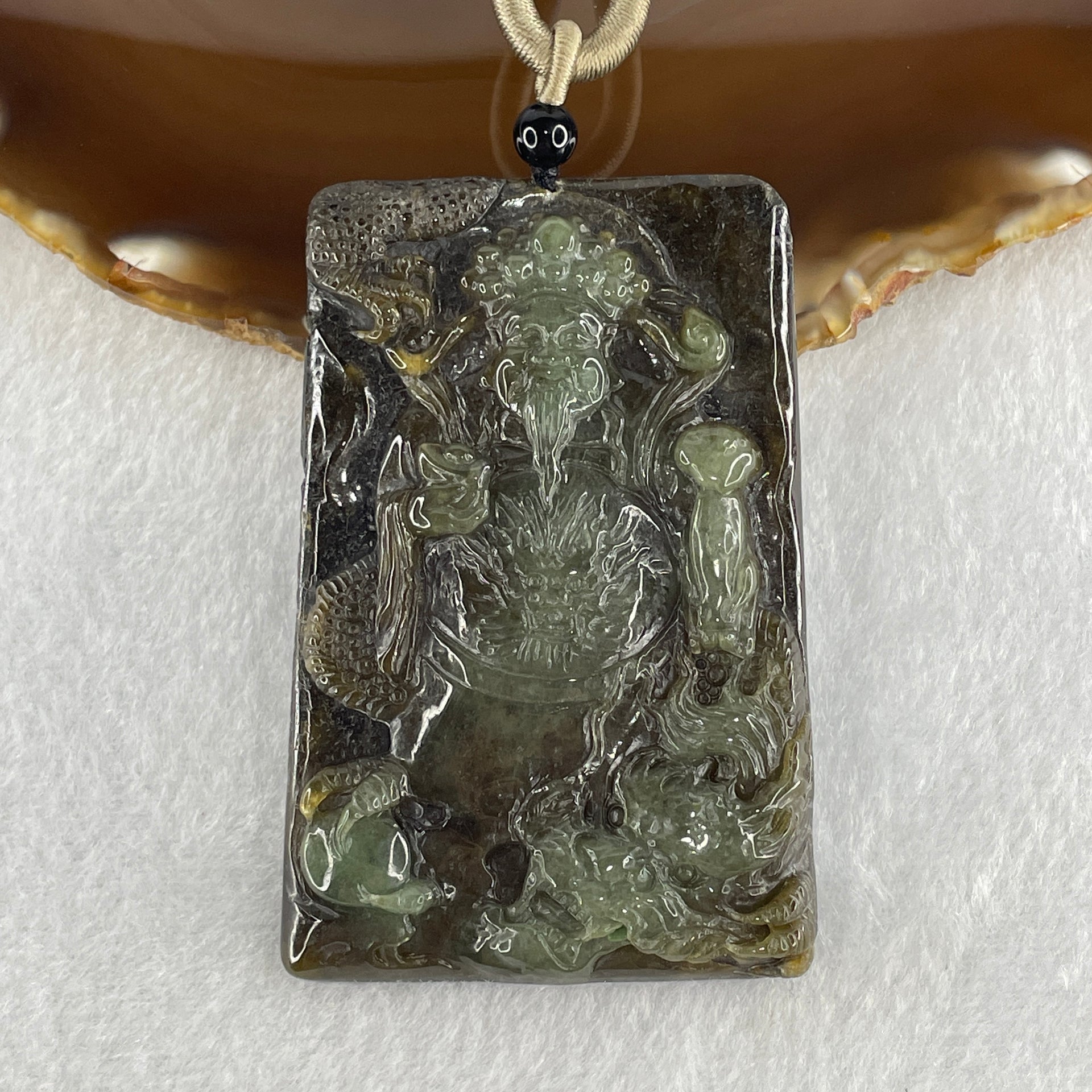 Translucent dark brown jadeite pendant carved as Cai Shen, Chinese God of Fortune