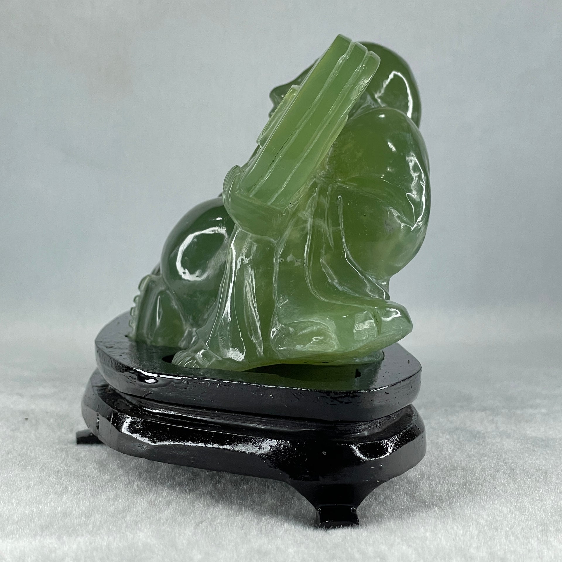 Natural Green Serpentine Siting Milo Buddha with Coin with Wooden Stand Display 1014.8g 200.0 by 100.0 by 105.0mm - Huangs Jadeite and Jewelry Pte Ltd