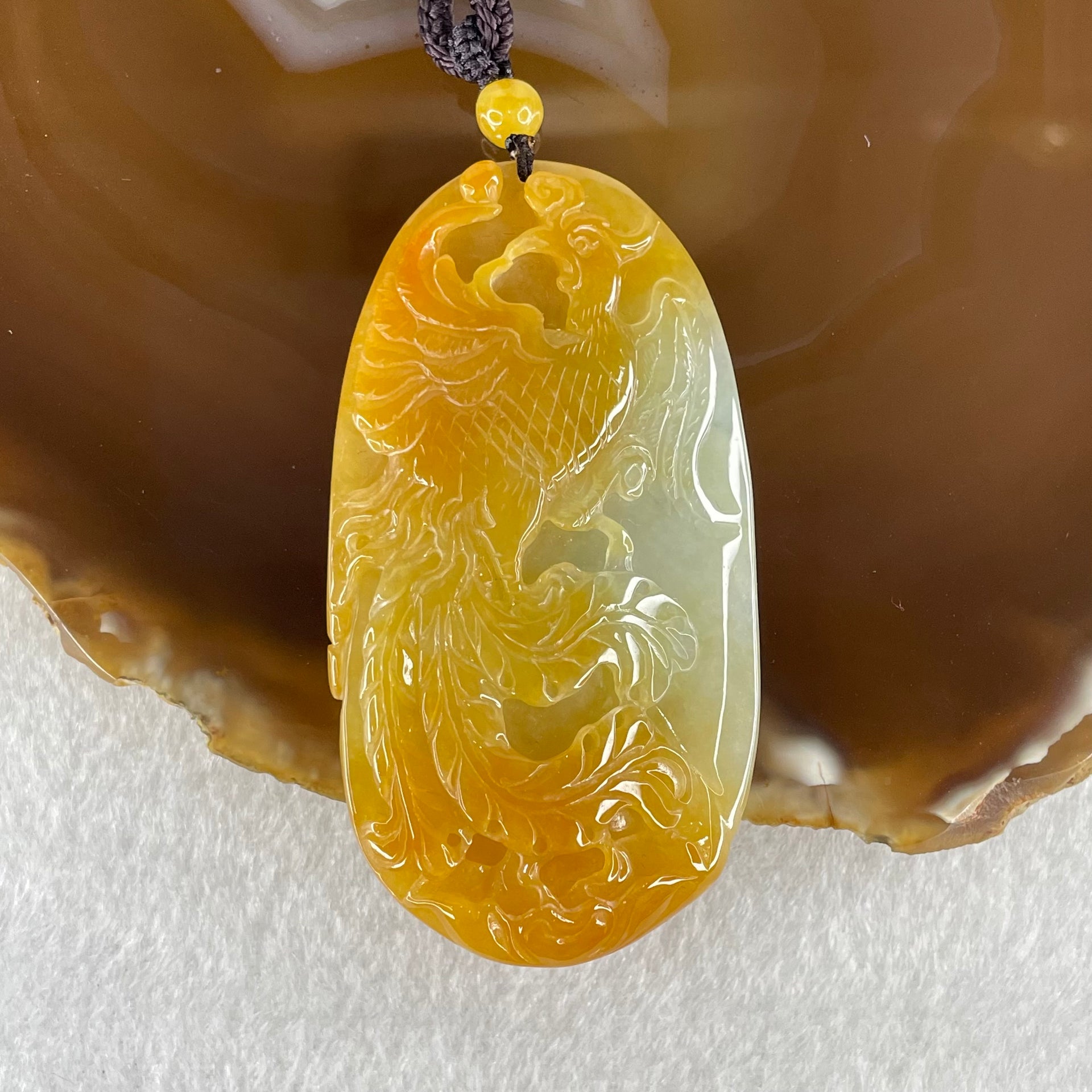 Grandmaster Type A Reddish Brown with Faint Lavender Green Jadeite Phoenix 凤戏牡丹 Pendant 41.26g 64.96 by 35.02 by 9.52mm With NGI Cert 82838779 - Huangs Jadeite and Jewelry Pte Ltd