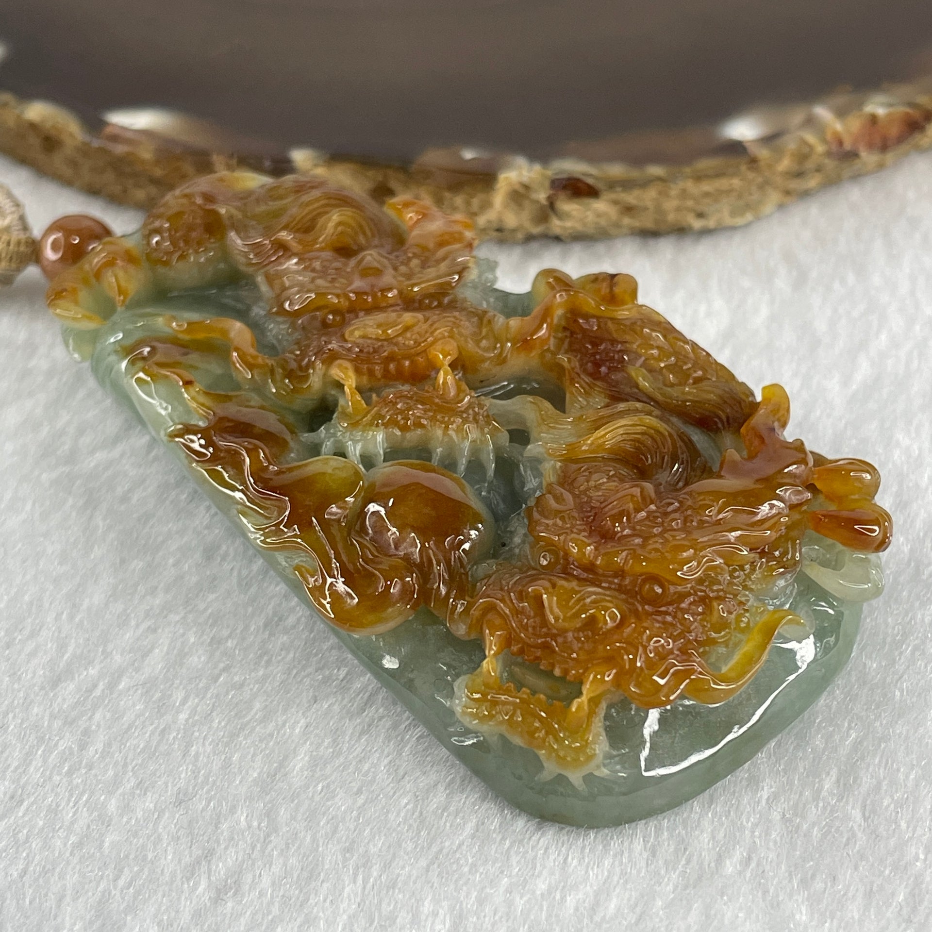 Grand Master Type A Green with Brownish Jadeite Dragon Double Side Pendant 125.78g 77.7 by 46.4 by 18.2mm - Huangs Jadeite and Jewelry Pte Ltd