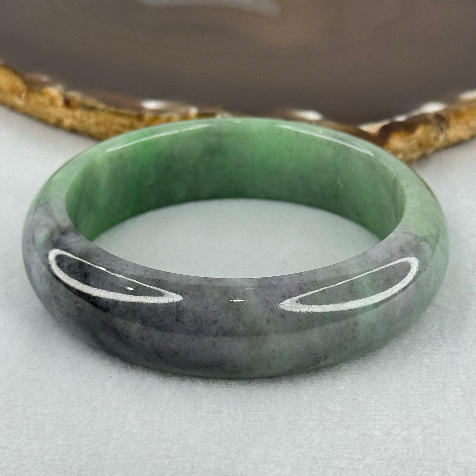 Type A Translucent Light Green with Patches of Faint Grey and Greyish Black Jadeite Bangle Internal Diameter 57.75mm 404.45cts 81.28g 17.3 by 9.0mm With NGI Cert No 32885808 (Very Slight Internal Lines) - Huangs Jadeite and Jewelry Pte Ltd