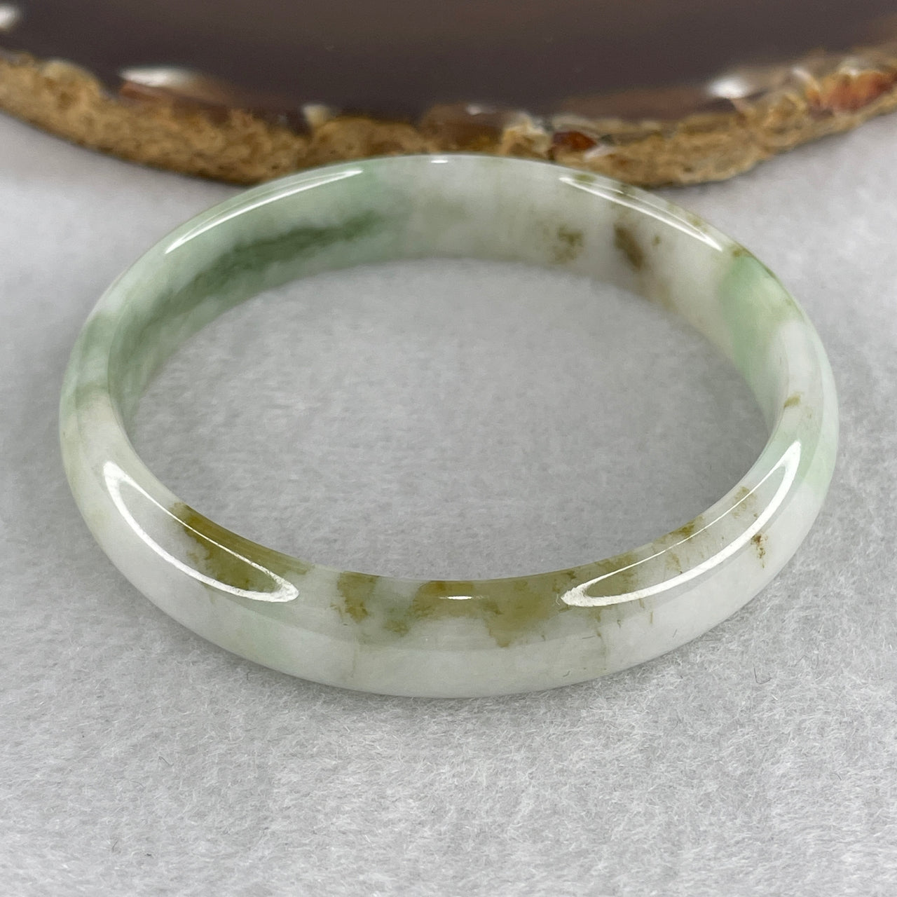 55.2mm Natural Type A Jadeite Bangle: Light Green Jade with Green and Brown Piao Hua (29.42g) - 11.1x6.7mm Width Genuine Burmese Jadeite (External and Internal Lines)