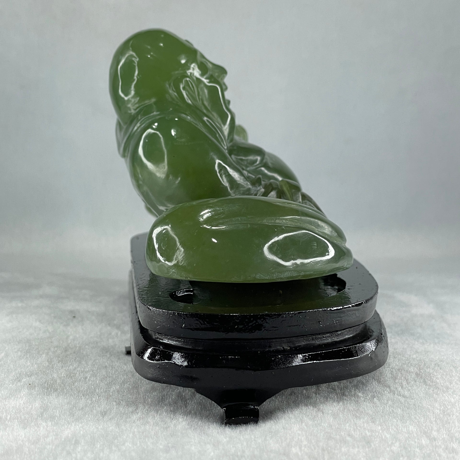Natural Green Serpentine Siting Milo Buddha with Coin with Wooden Stand Display 1014.8g 200.0 by 100.0 by 105.0mm - Huangs Jadeite and Jewelry Pte Ltd