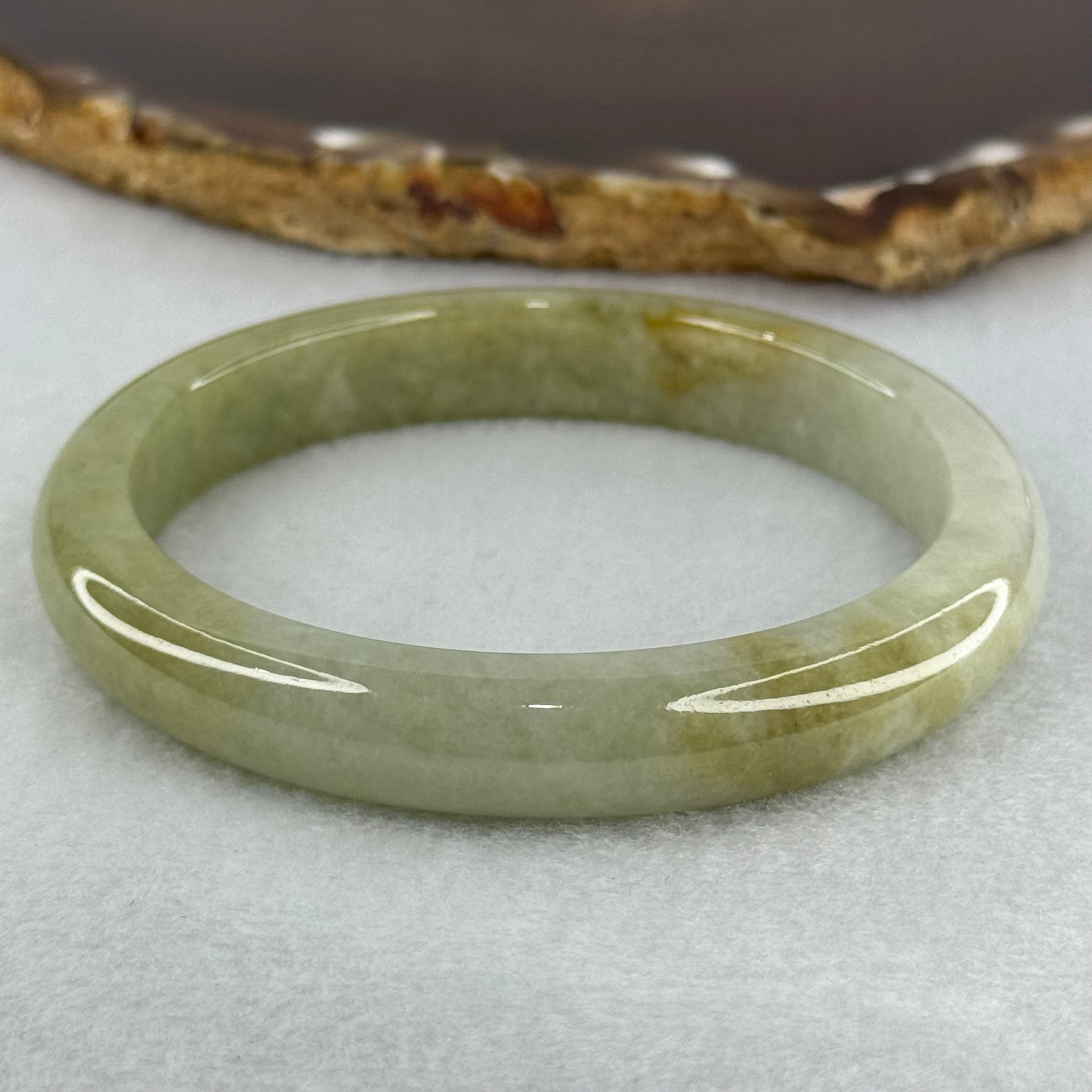 Type A Yellowish Green Lavender Jadeite Oval Bangle Internal Diameter 58.5mm 67.31g 10.7 by 8.1mm (Very Slight Fine Internal Line) - Huangs Jadeite and Jewelry Pte Ltd