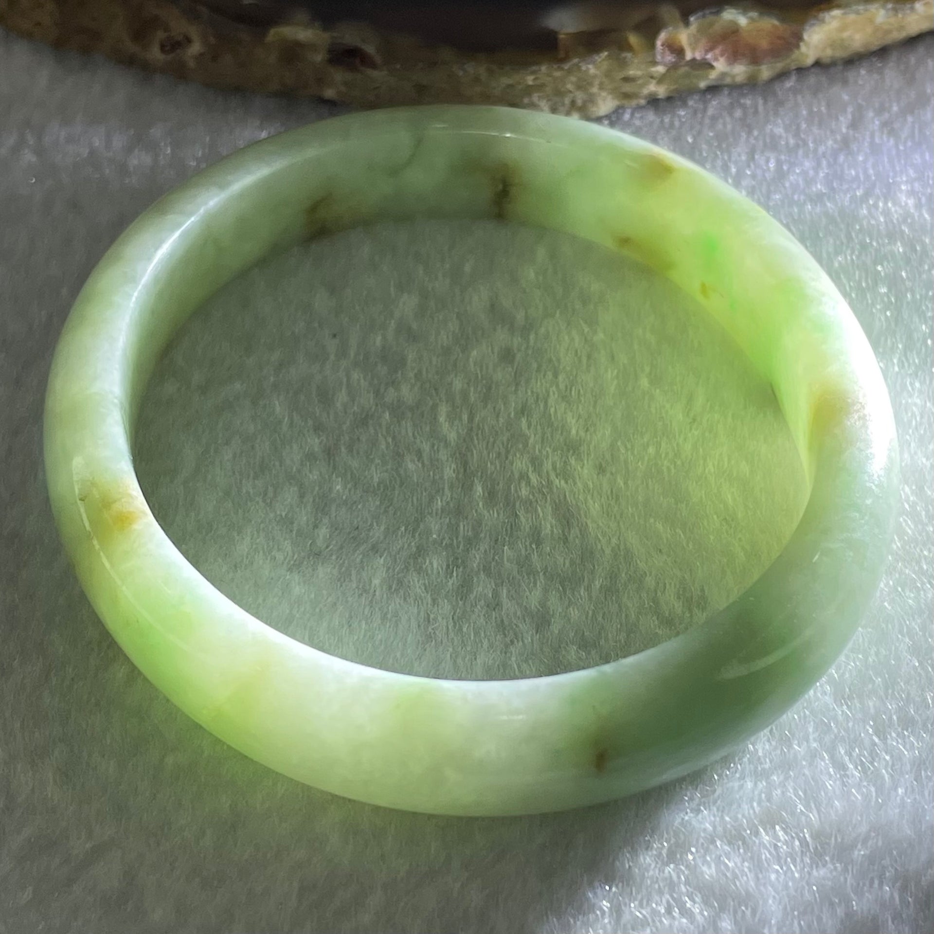 Type A Green with Brown Patches Jadeite Oval Bangle 31.51g Internal Diameter 55.6mm 10.3 by 6.6mm (External Roughs and Internal Lines) - Huangs Jadeite and Jewelry Pte Ltd