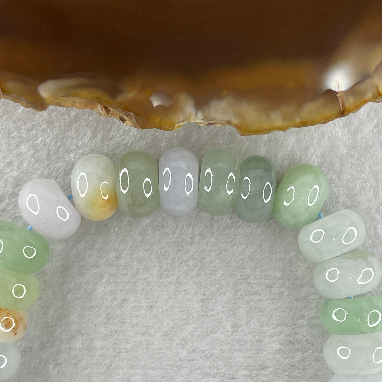 Natural Type A Light Green Light Lavender and Slight Yellow Jadeite Donut Shape Beads with Colourless Wuji Spots Jadeite Money Bag in Gold Color Charm 21.0 by 16.2 by 6.3mm Bracelet 45.51g 15.5cm 10.4mm 31 Beads