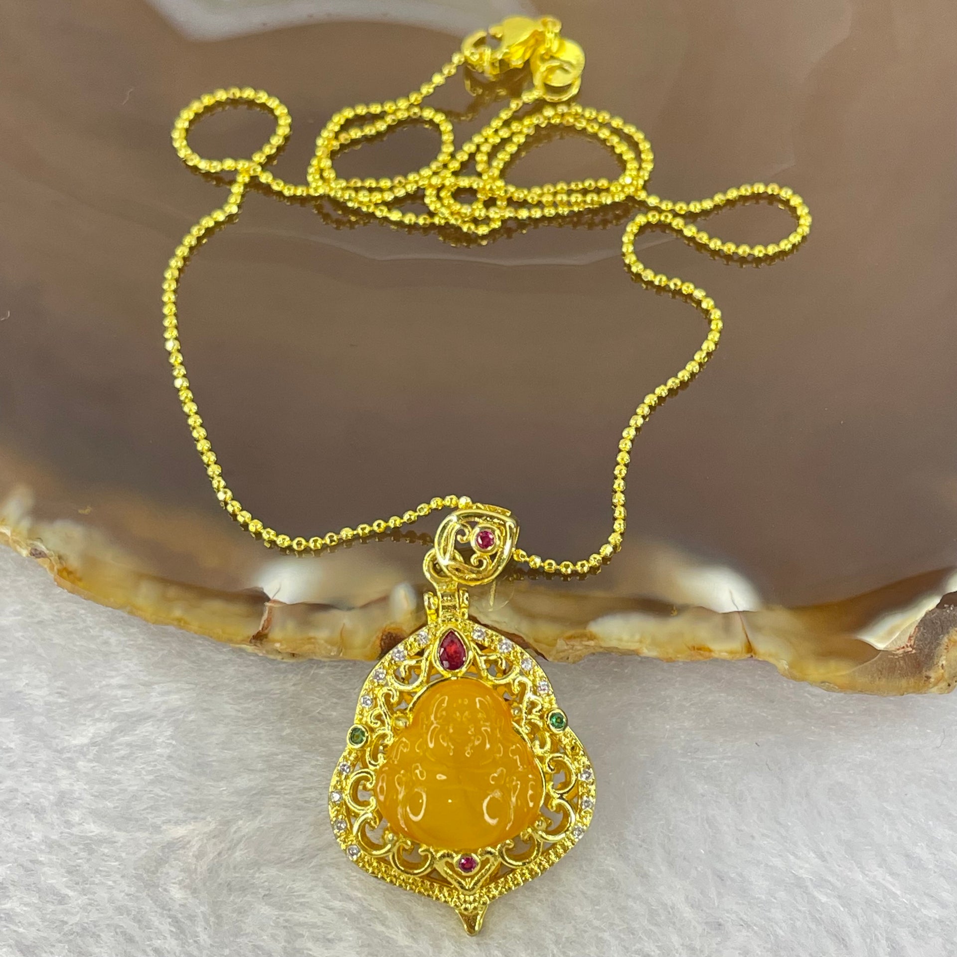 Natural Butterscotch Amber Milo Buddha with Crystals in Gold Color Necklace 5.64g 12.2 by 11.8 by 3.2mm - Huangs Jadeite and Jewelry Pte Ltd