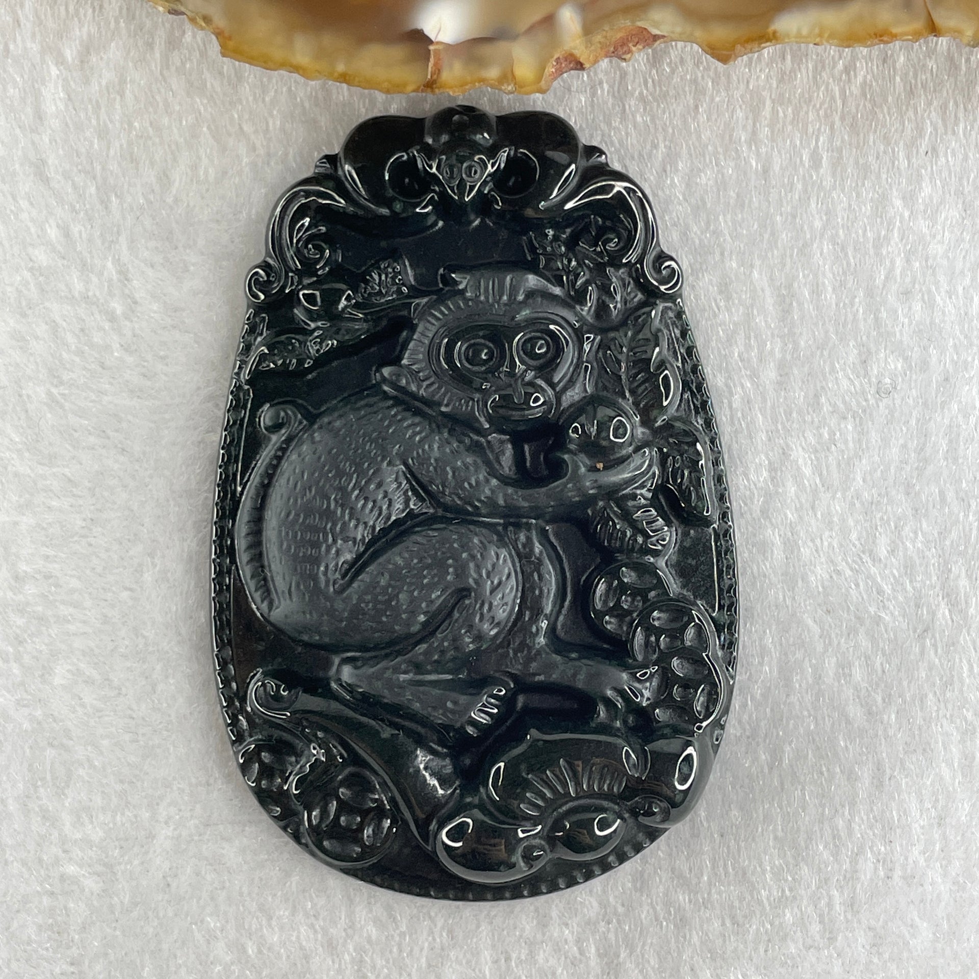 Type A Opaque to Partial Translucent Black Omphacite Jadeite Monkey Pendant 29.60g 59.6 by 40.1 by 8.5mm - Huangs Jadeite and Jewelry Pte Ltd