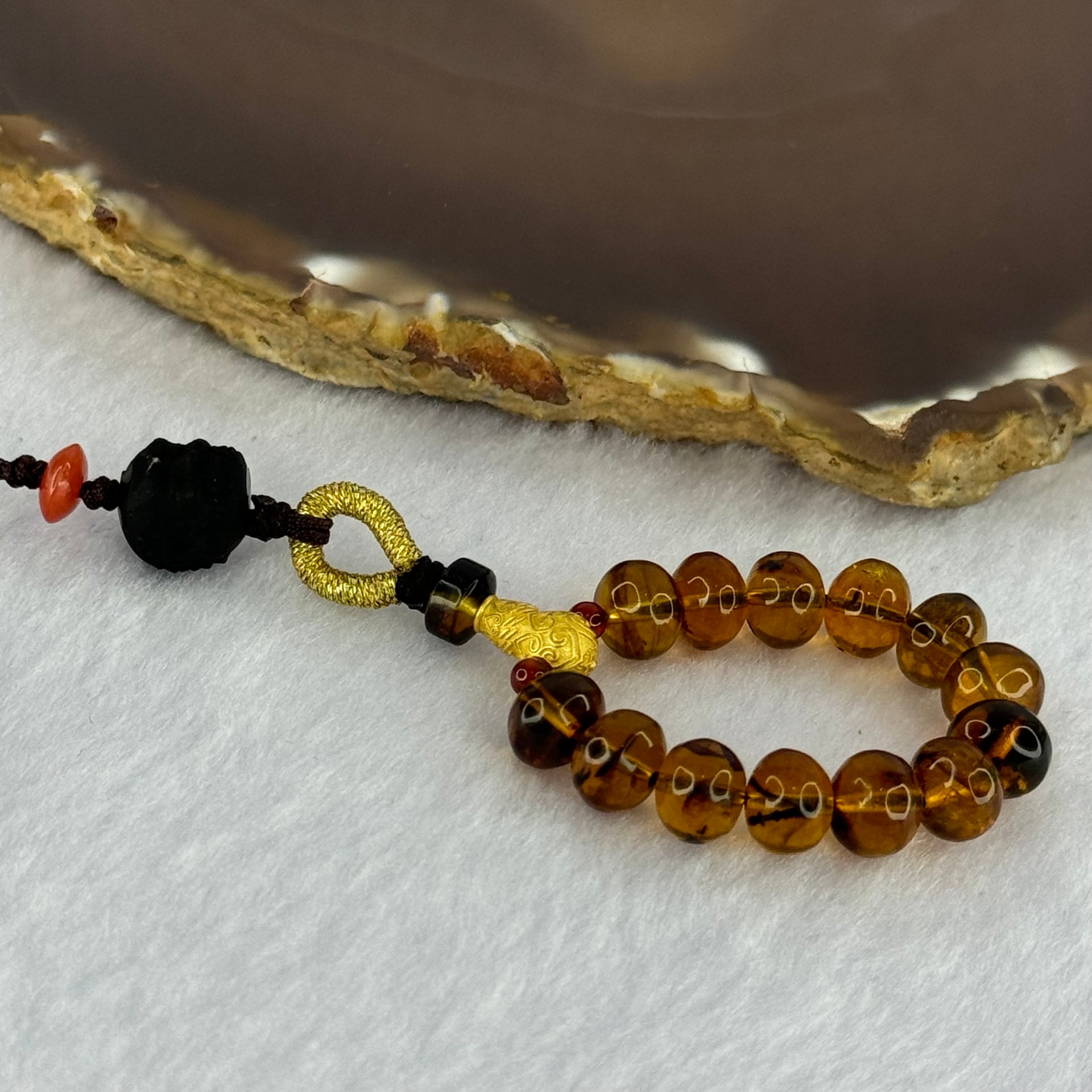 Natural Cognac Amber with Damo Head Handphone Strap 4.30g 7.6mm 13 Beads - Huangs Jadeite and Jewelry Pte Ltd