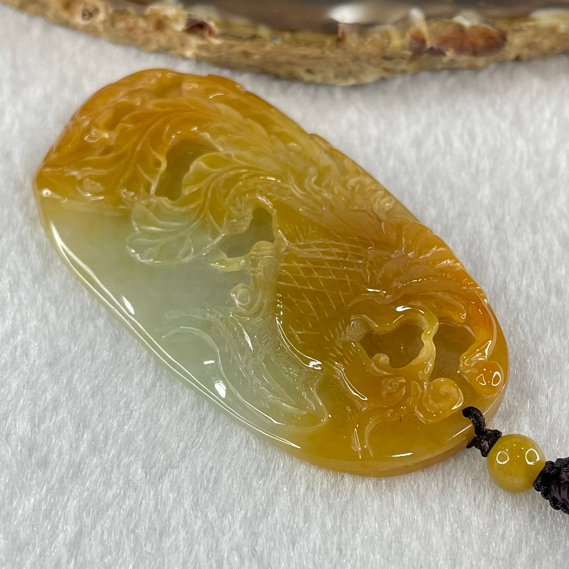Grandmaster Type A Reddish Brown with Faint Lavender Green Jadeite Phoenix 凤戏牡丹 Pendant 41.26g 64.96 by 35.02 by 9.52mm With NGI Cert 82838779 - Huangs Jadeite and Jewelry Pte Ltd