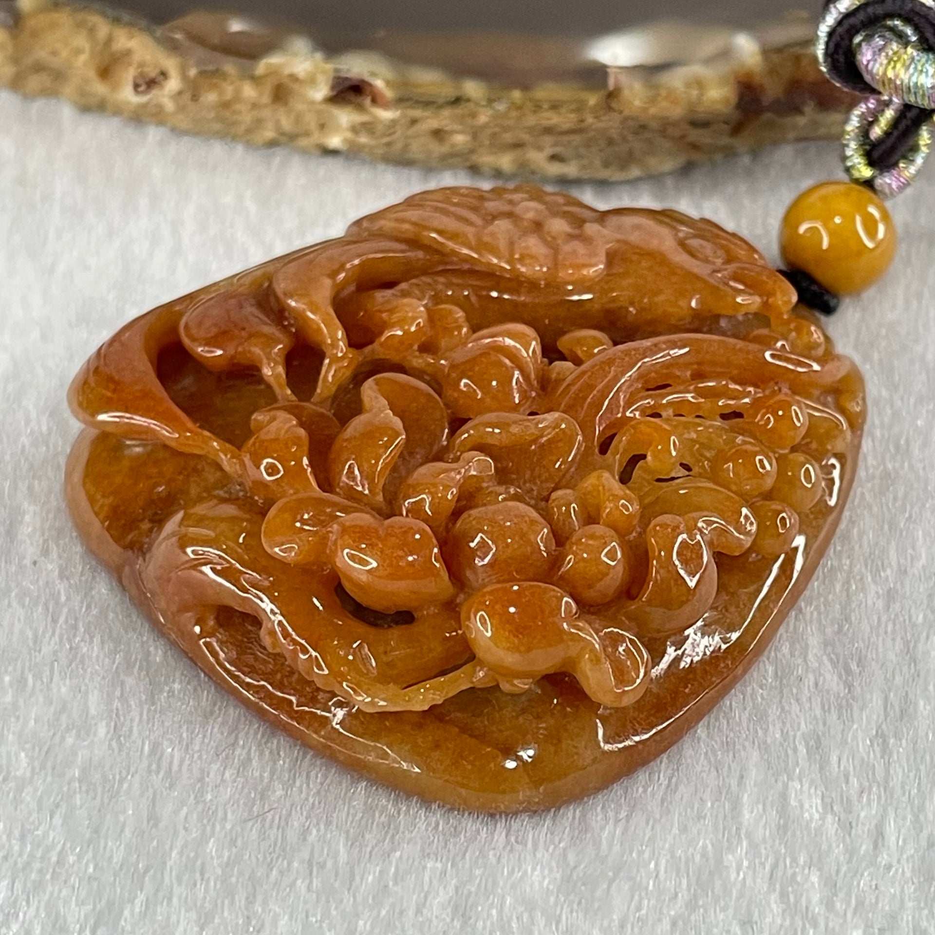 Grandmaster Type A Translucent Brownish Orange to Brownish Red with Light Blueish Green Jadeite Bird with Flower 花开富贵 Pendant 53.67g 49.27 by 46.37 by 12.66mm With NGI Cert 82838746 - Huangs Jadeite and Jewelry Pte Ltd