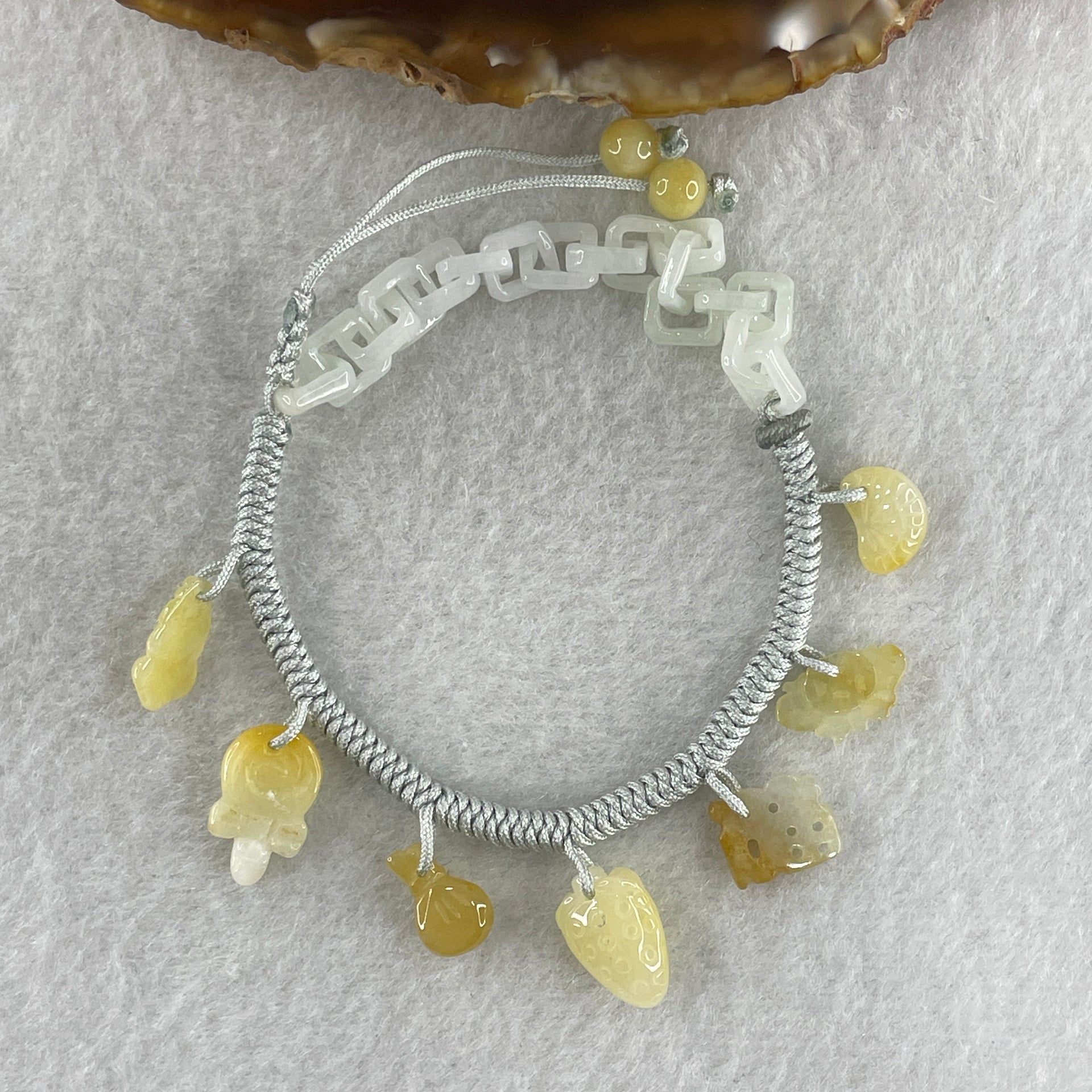 Natural Type A Yellowish Jadeite Money Bag Hulu Fu Butterfly in String Bracelet 8.79g 16-20cm 12.7 by 8.8 by 6.9mm - Huangs Jadeite and Jewelry Pte Ltd