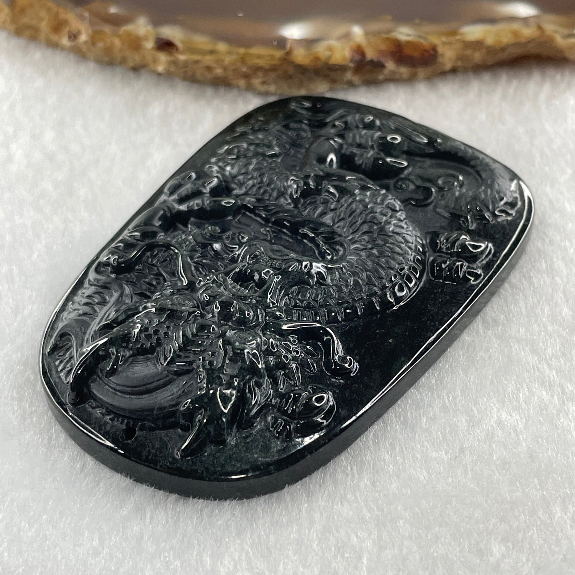 Type A Opaque to Partial Translucent Black Omphacite Jadeite Dragon Pendant 34.19g 66.8 by 45.5 by 9.4mm - Huangs Jadeite and Jewelry Pte Ltd