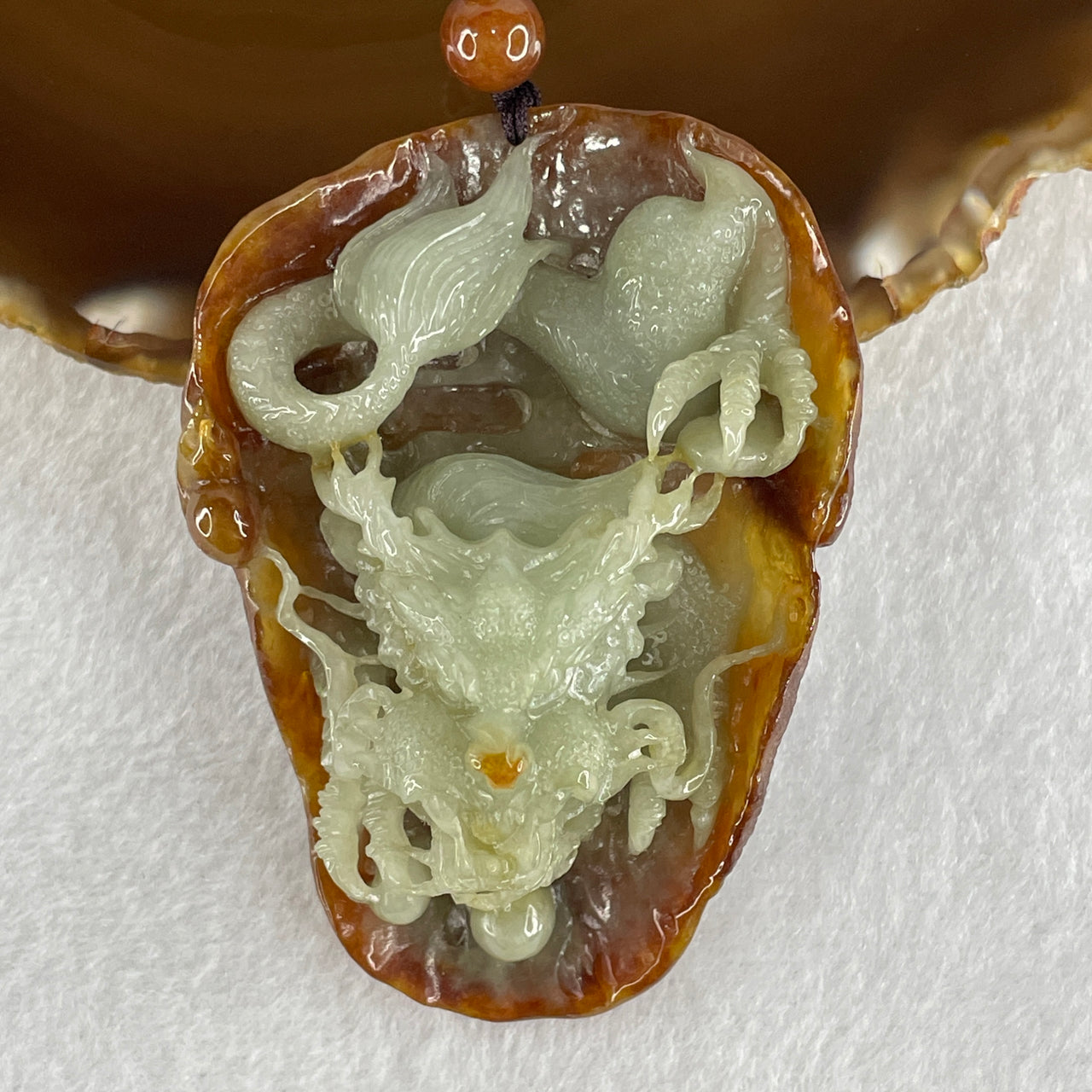 Type A Green with Brownish Jadeite Dragon Pendant 75.51g 68.8 by 49.5 by 28.9mm