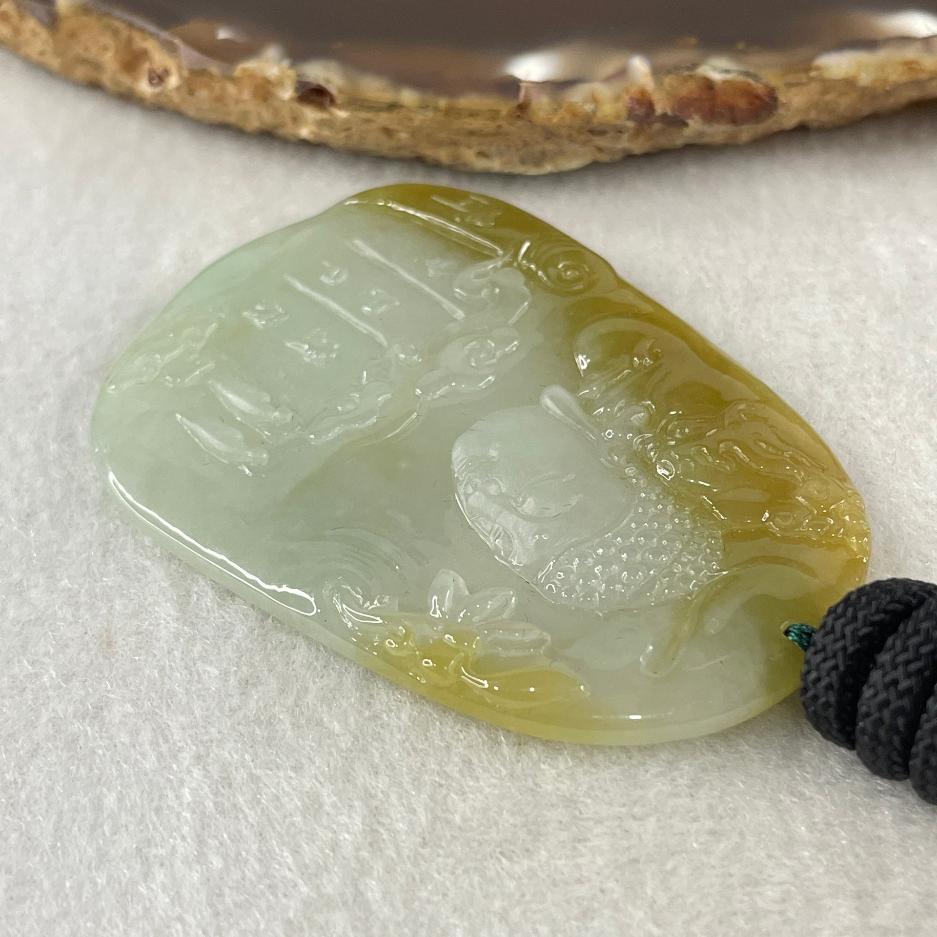 Grand Master Type A Faint Blueish Green with Yellowish Brown Jadeite Good Vs Evil Pendant 22.60g 60.3 by 43.3 by 4.0mm - Huangs Jadeite and Jewelry Pte Ltd