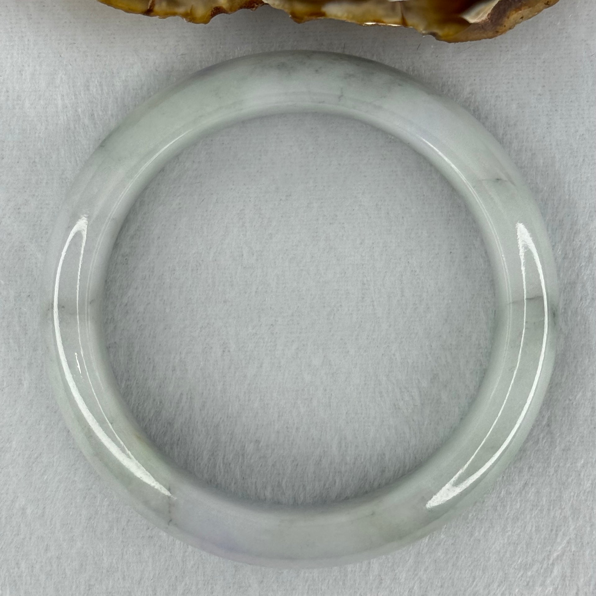 Type A Translucent Faint Blueish Green with Patches of Light Grey and Faint Lavender Jadeite Bangle Internal Diameter 56.95mm 344.09cts 69.22g 14.6 by 8.9mm With NGI Cert No 32886054 (Very Slight Internal Line) - Huangs Jadeite and Jewelry Pte Ltd