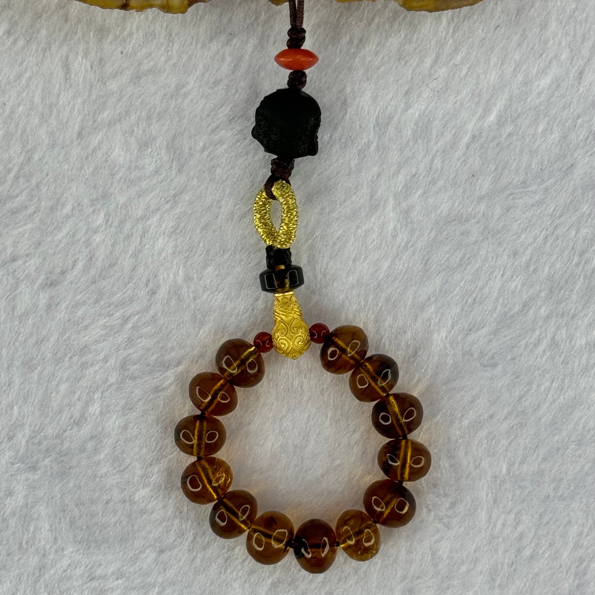 Natural Cognac Amber with Damo Head Handphone Strap 4.30g 7.6mm 13 Beads - Huangs Jadeite and Jewelry Pte Ltd