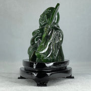 Natural Dark Green Serpentine Siting Milo Buddha with Waving Fan with Wooden Stand Display 765.0g 180.0 by 90.0 by 115.0mm - Huangs Jadeite and Jewelry Pte Ltd