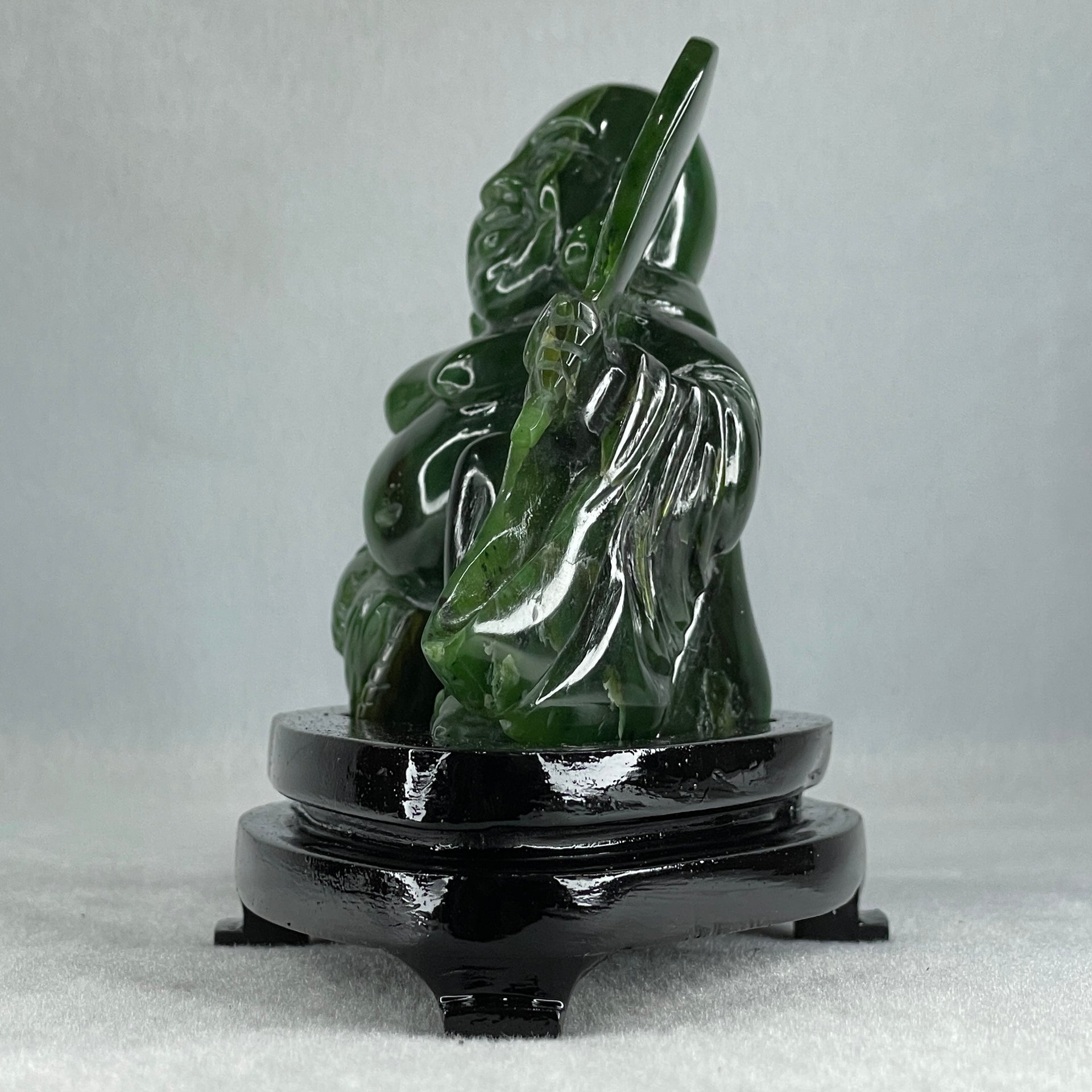 Natural Dark Green Serpentine Siting Milo Buddha with Waving Fan with Wooden Stand Display 765.0g 180.0 by 90.0 by 115.0mm - Huangs Jadeite and Jewelry Pte Ltd