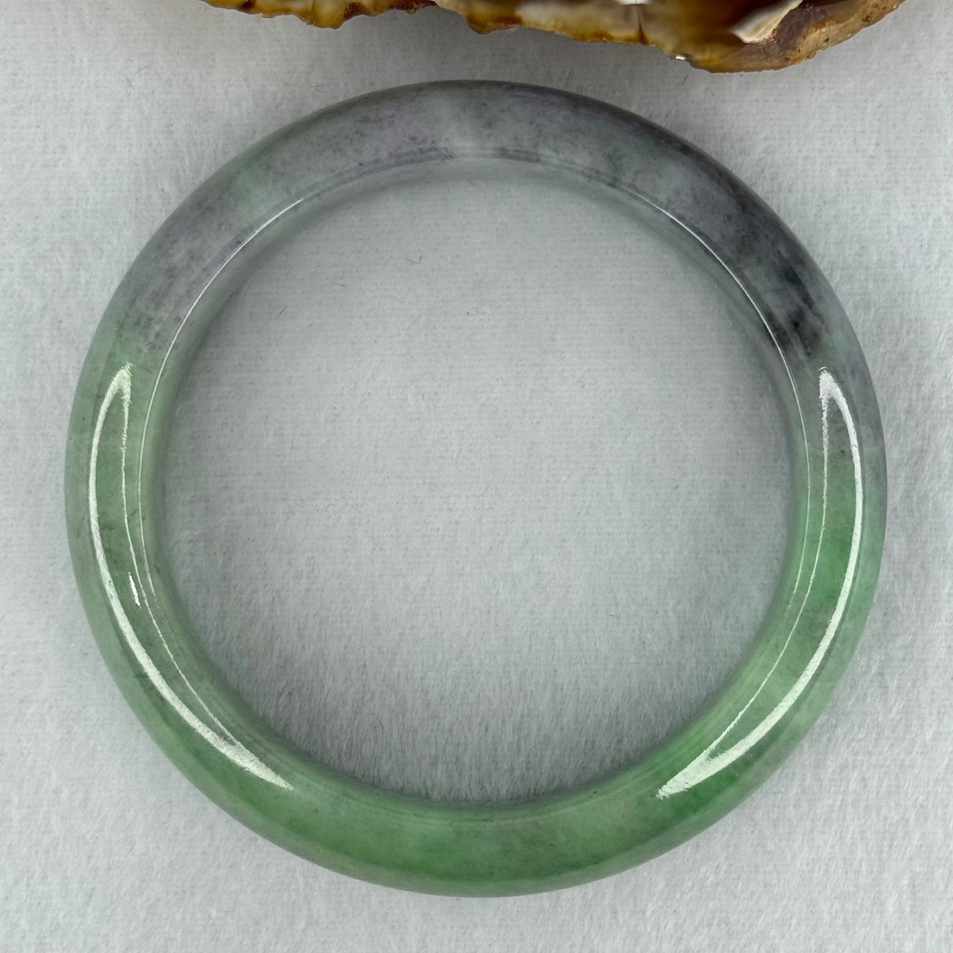 Type A Translucent Light Green with Patches of Faint Grey and Greyish Black Jadeite Bangle Internal Diameter 57.75mm 404.45cts 81.28g 17.3 by 9.0mm With NGI Cert No 32885808 (Very Slight Internal Lines) - Huangs Jadeite and Jewelry Pte Ltd