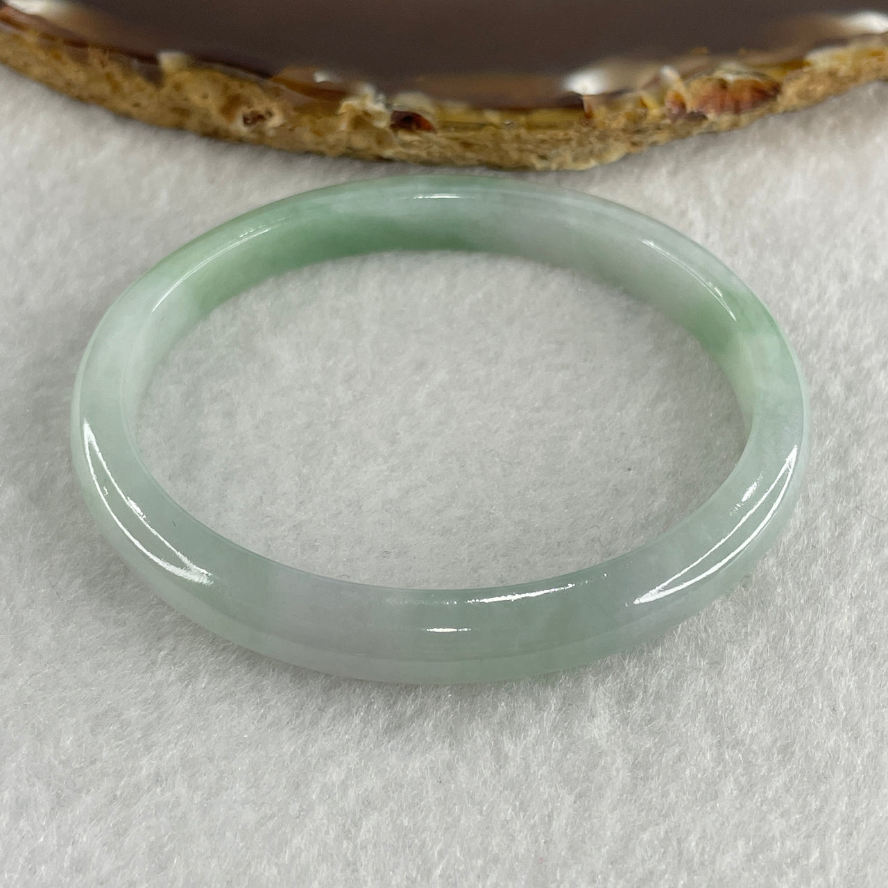 Certified Type A Light Green with Green Patches Jadeite Oval Bangle Internal Diameter 54.3mm 20.69g 7.5 by 6.4mm ( Very Slight Internal Lines )
