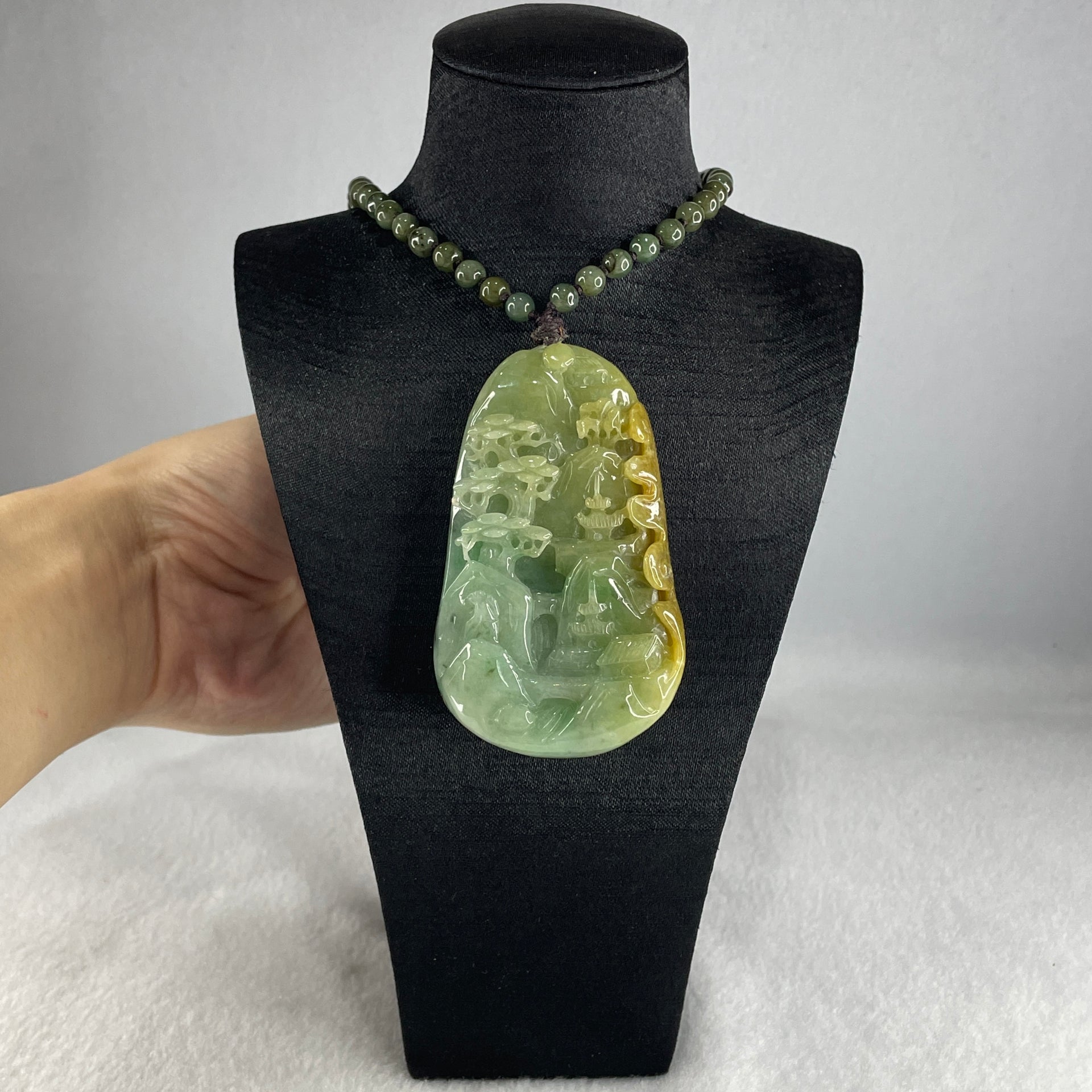 Natural Type A Green with Yellowish Jadeite Shan Shui with Gui Ren Pendant 127.68g 75.0 by 44.7 by 14.7mm - Huangs Jadeite and Jewelry Pte Ltd
