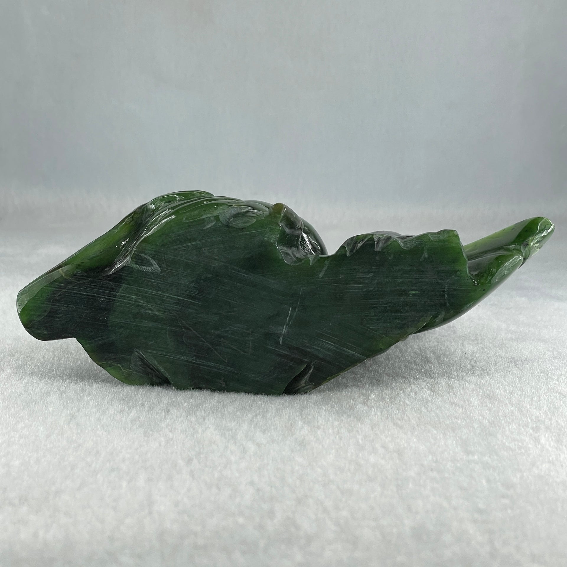 Natural Dark Green Serpentine Siting Milo Buddha with Waving Fan with Wooden Stand Display 765.0g 180.0 by 90.0 by 115.0mm - Huangs Jadeite and Jewelry Pte Ltd