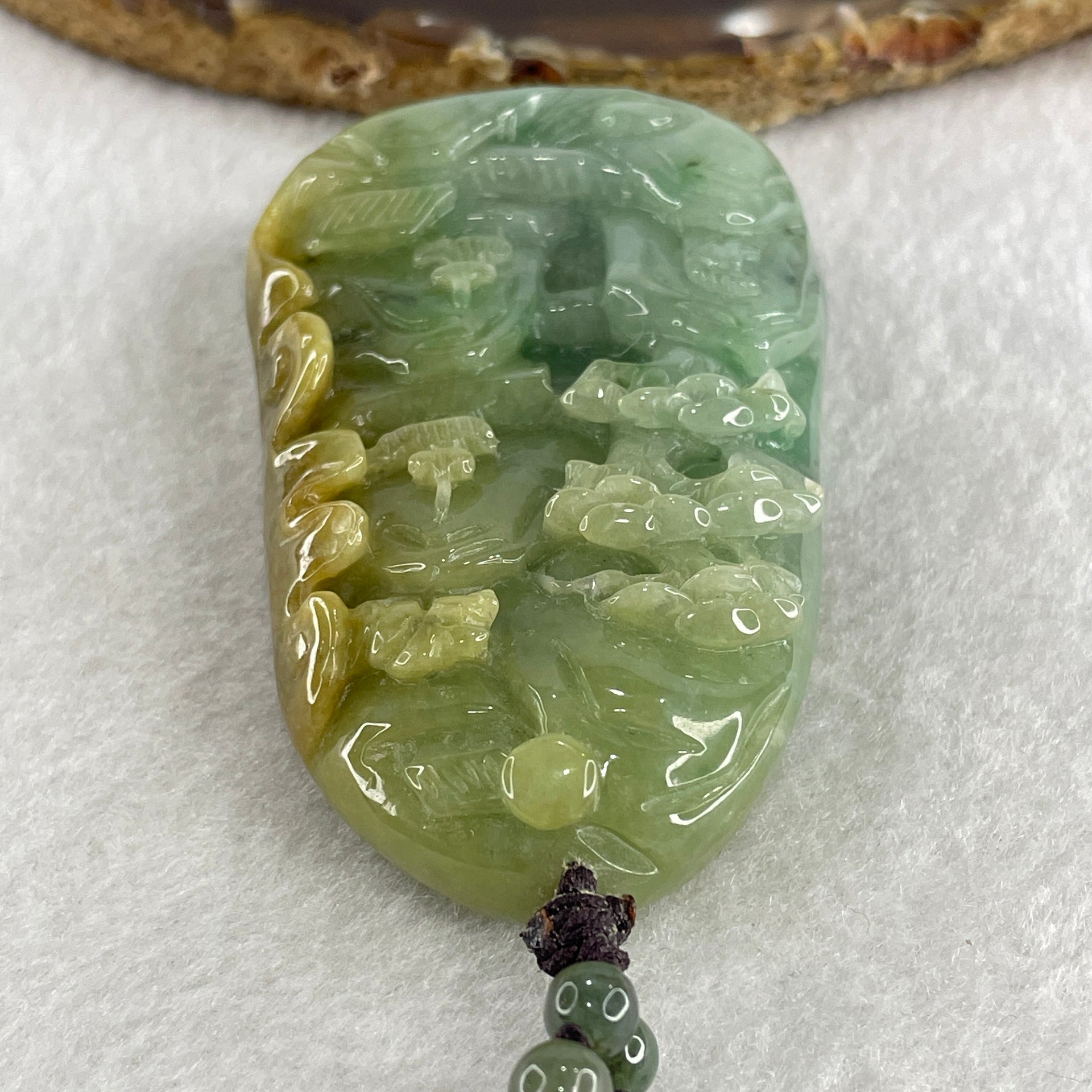 Natural Type A Green with Yellowish Jadeite Shan Shui with Gui Ren Pendant 127.68g 75.0 by 44.7 by 14.7mm - Huangs Jadeite and Jewelry Pte Ltd