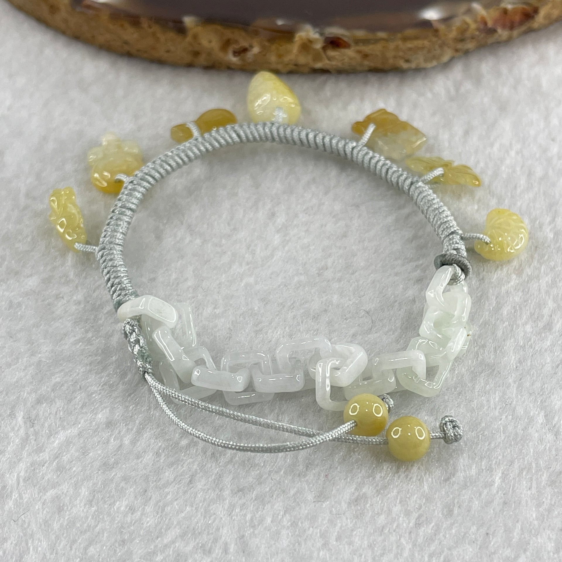 Natural Type A Yellowish Jadeite Money Bag Hulu Fu Butterfly in String Bracelet 8.79g 16-20cm 12.7 by 8.8 by 6.9mm - Huangs Jadeite and Jewelry Pte Ltd