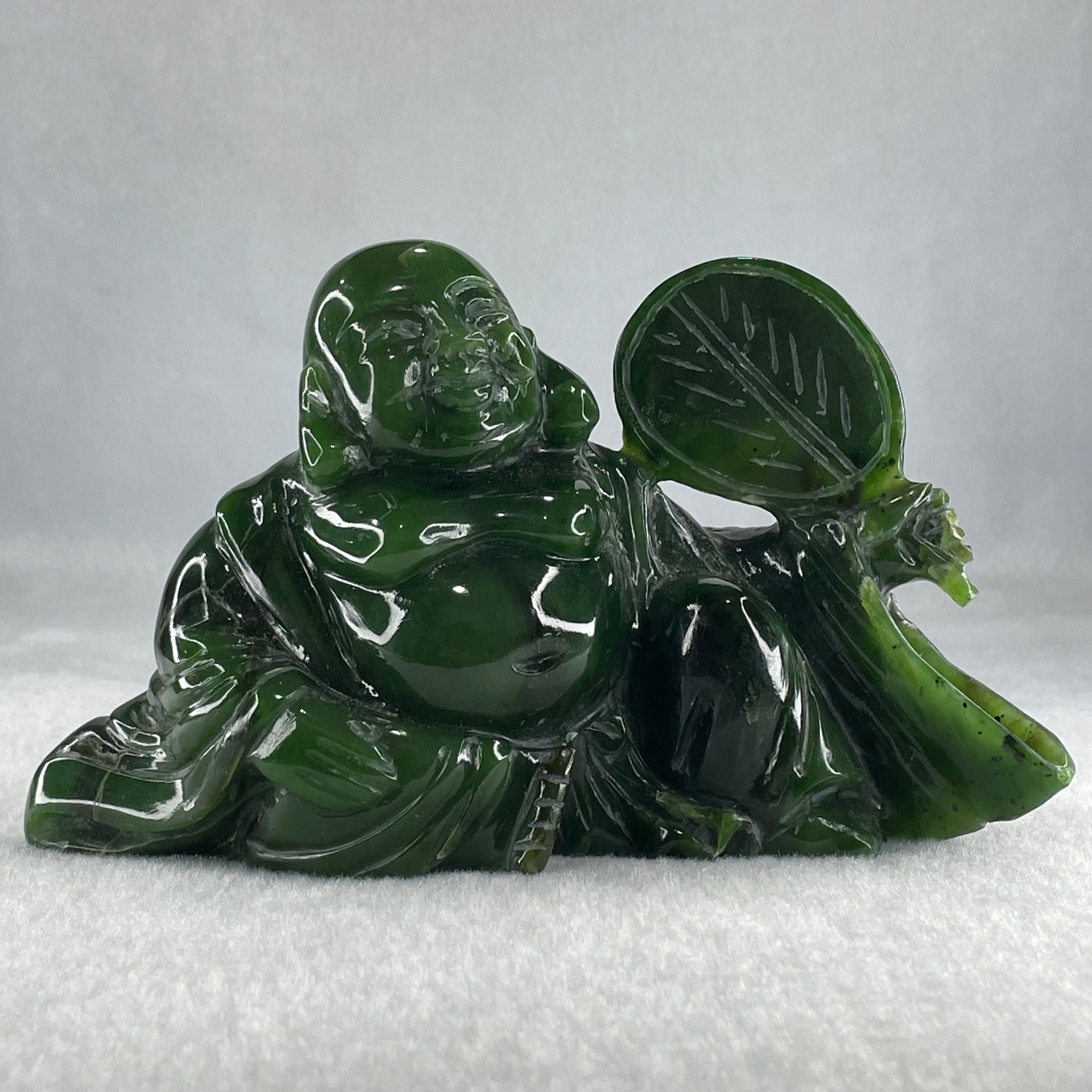 Natural Dark Green Serpentine Siting Milo Buddha with Waving Fan with Wooden Stand Display 765.0g 180.0 by 90.0 by 115.0mm - Huangs Jadeite and Jewelry Pte Ltd