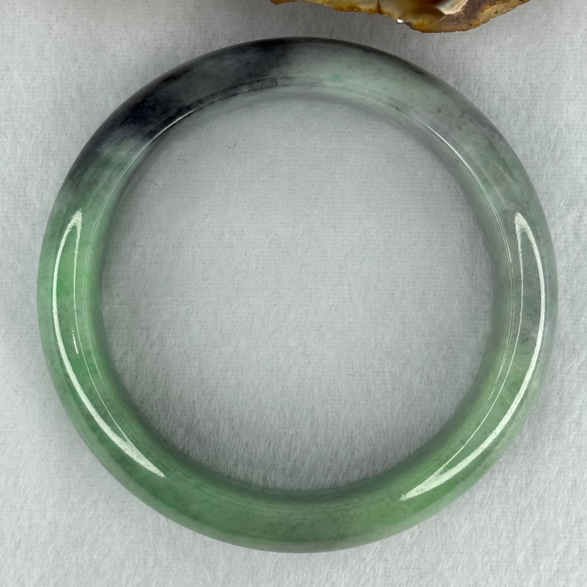 Type A Translucent Light Green with Patches of Faint Grey and Greyish Black Jadeite Bangle Internal Diameter 57.75mm 404.45cts 81.28g 17.3 by 9.0mm With NGI Cert No 32885808 (Very Slight Internal Lines) - Huangs Jadeite and Jewelry Pte Ltd