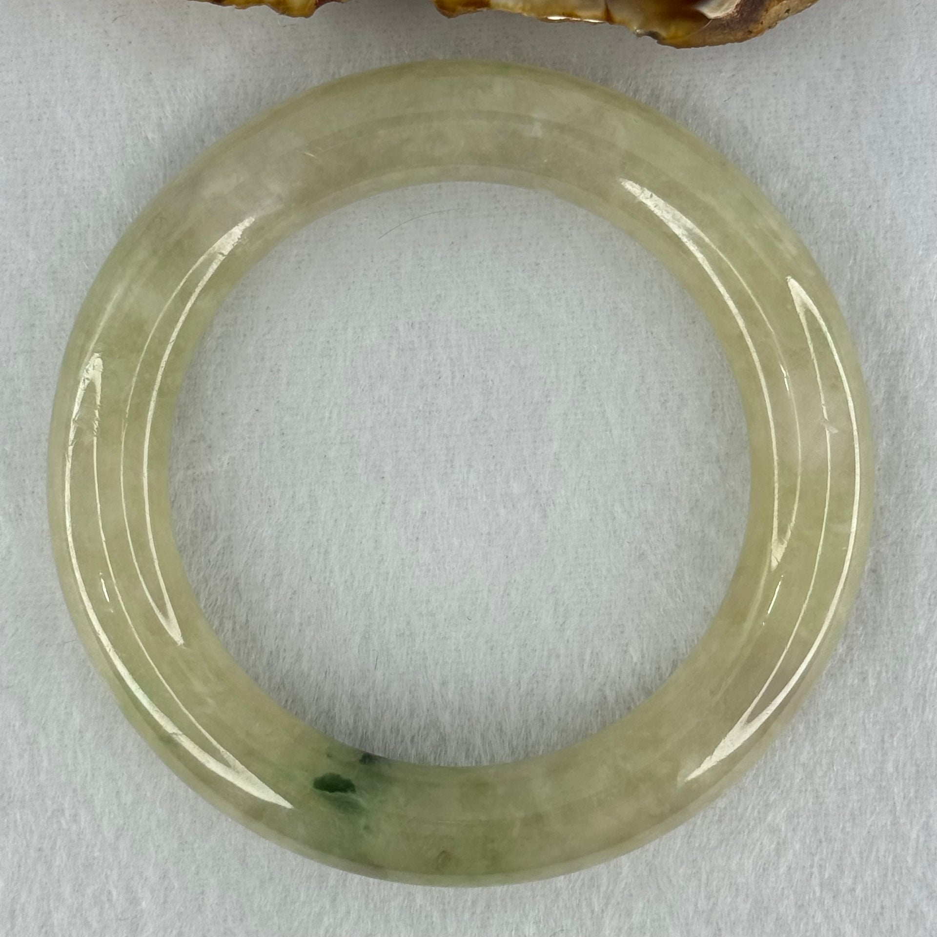 Type A Translucent Semi Icy Light Yellowish Green with Moss Green Patch Jadeite Bangle Internal Diameter 55.3mm 76.40g 12.3 by 11.6mm (Very Slight External Rough) - Huangs Jadeite and Jewelry Pte Ltd