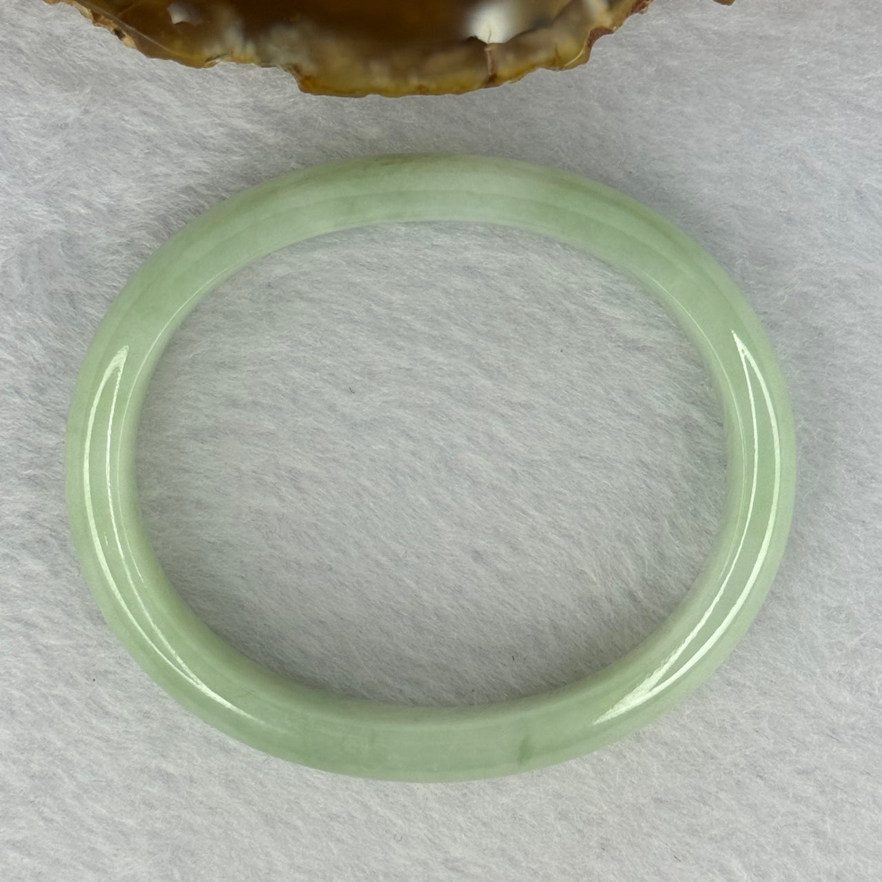 Type A Light Apple Green Jadeite Oval Bangle 33.35g Internal Diameter 52.3mm 12.2 by 6.5mm (Very Slight Fine Internal Lines) - Huangs Jadeite and Jewelry Pte Ltd