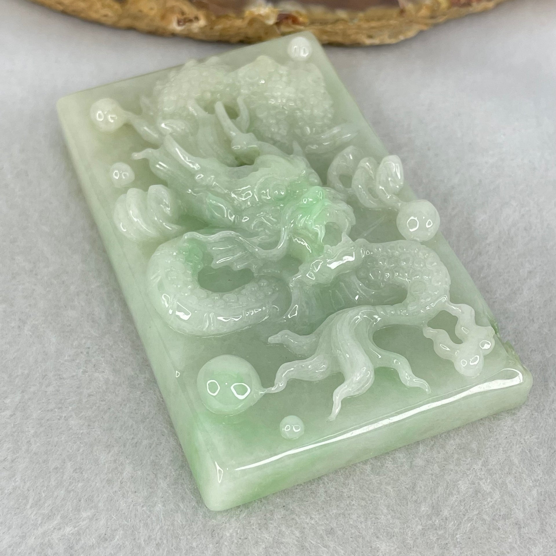 Type A Light Apple Green Jadeite Dragon Pendant 87.90g 69.4 by 44.2 by 14.2mm - Huangs Jadeite and Jewelry Pte Ltd