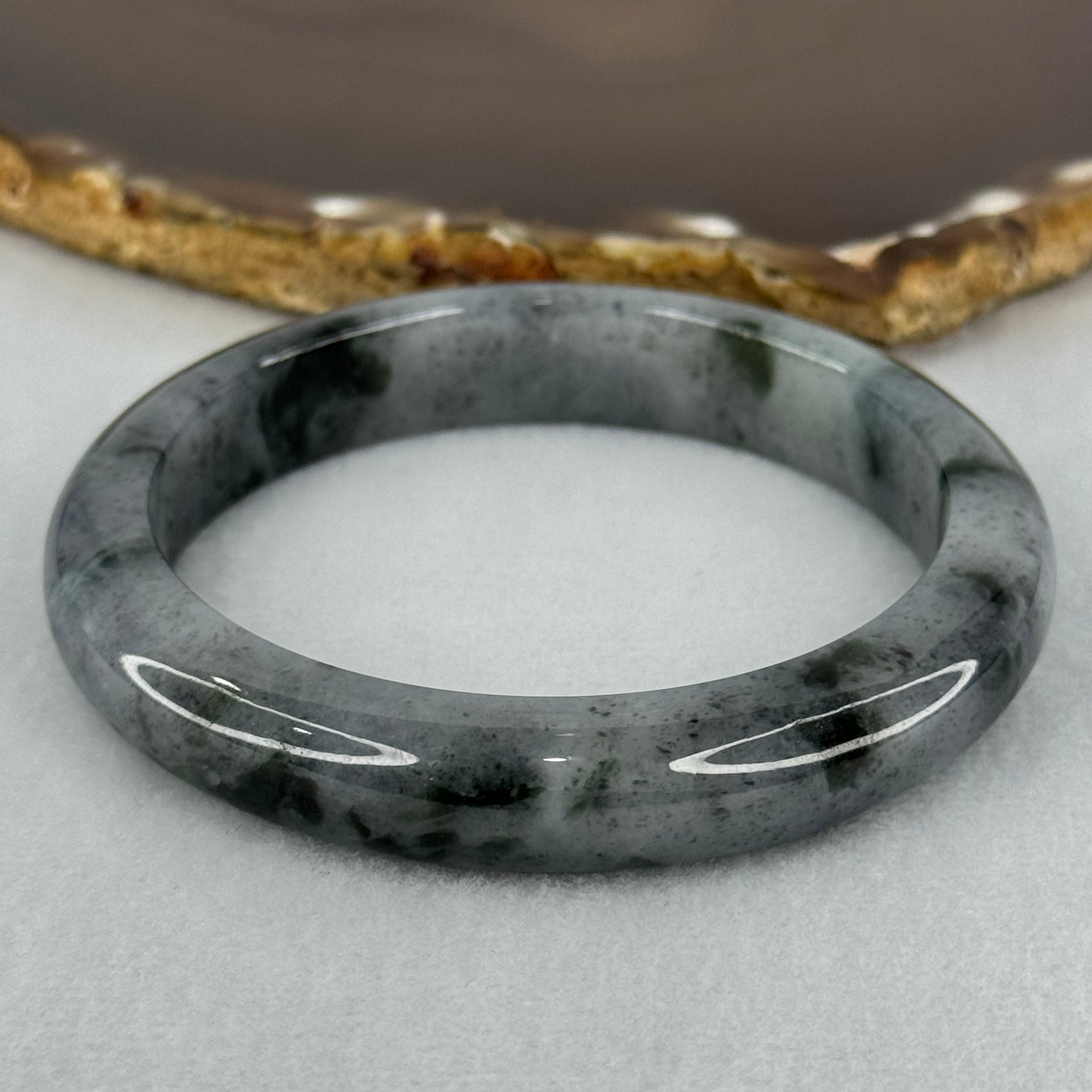 Type A Translucent Faint Grey with Greyish Black Patches Jadeite Bangle Internal Diameter 58.55mm 289.81cts 58.40g 11.8 by 8.6mm With NGI Cert 32885981 (Very Slight Internal Lines) - Huangs Jadeite and Jewelry Pte Ltd