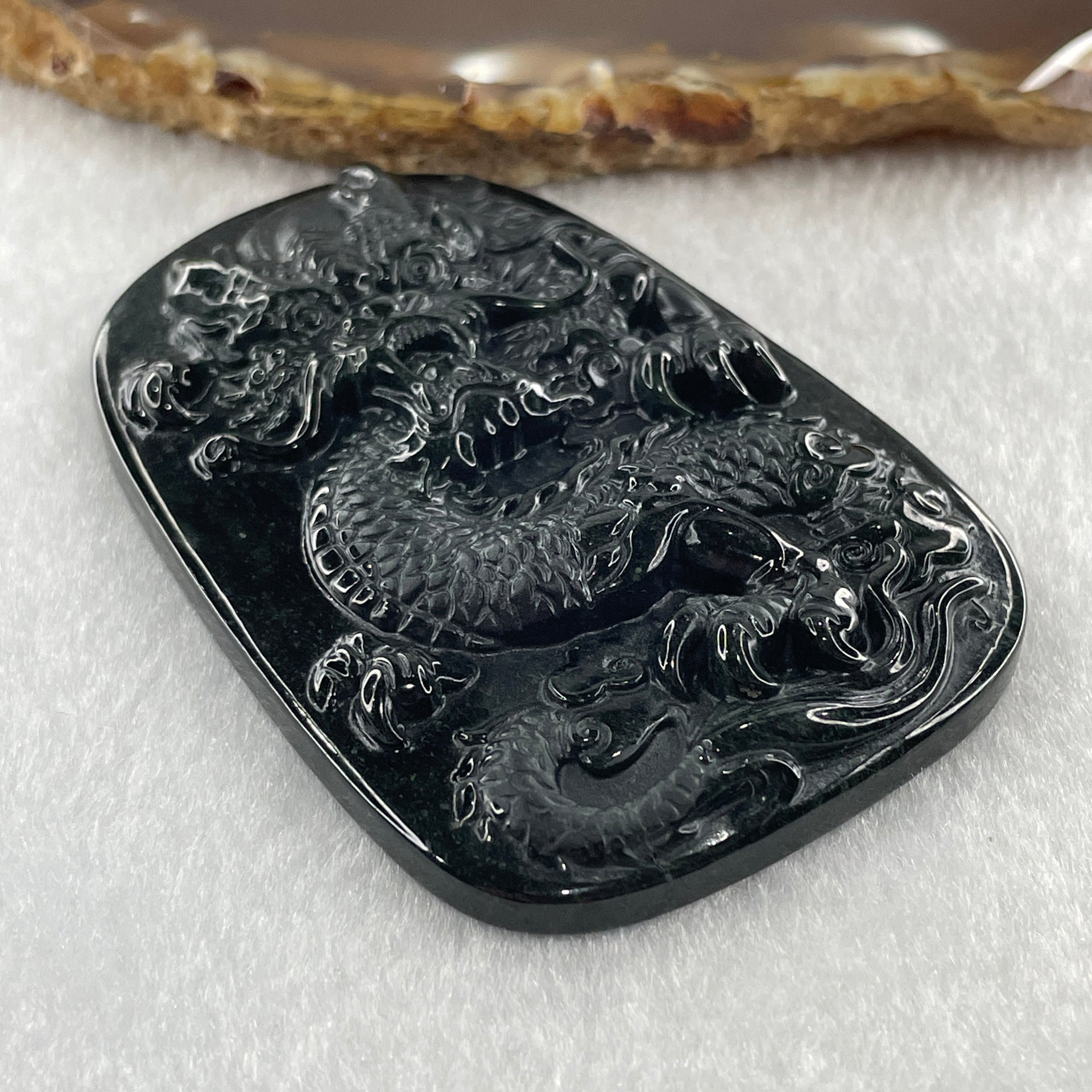 Type A Opaque to Partial Translucent Black Omphacite Jadeite Dragon Pendant 34.19g 66.8 by 45.5 by 9.4mm - Huangs Jadeite and Jewelry Pte Ltd