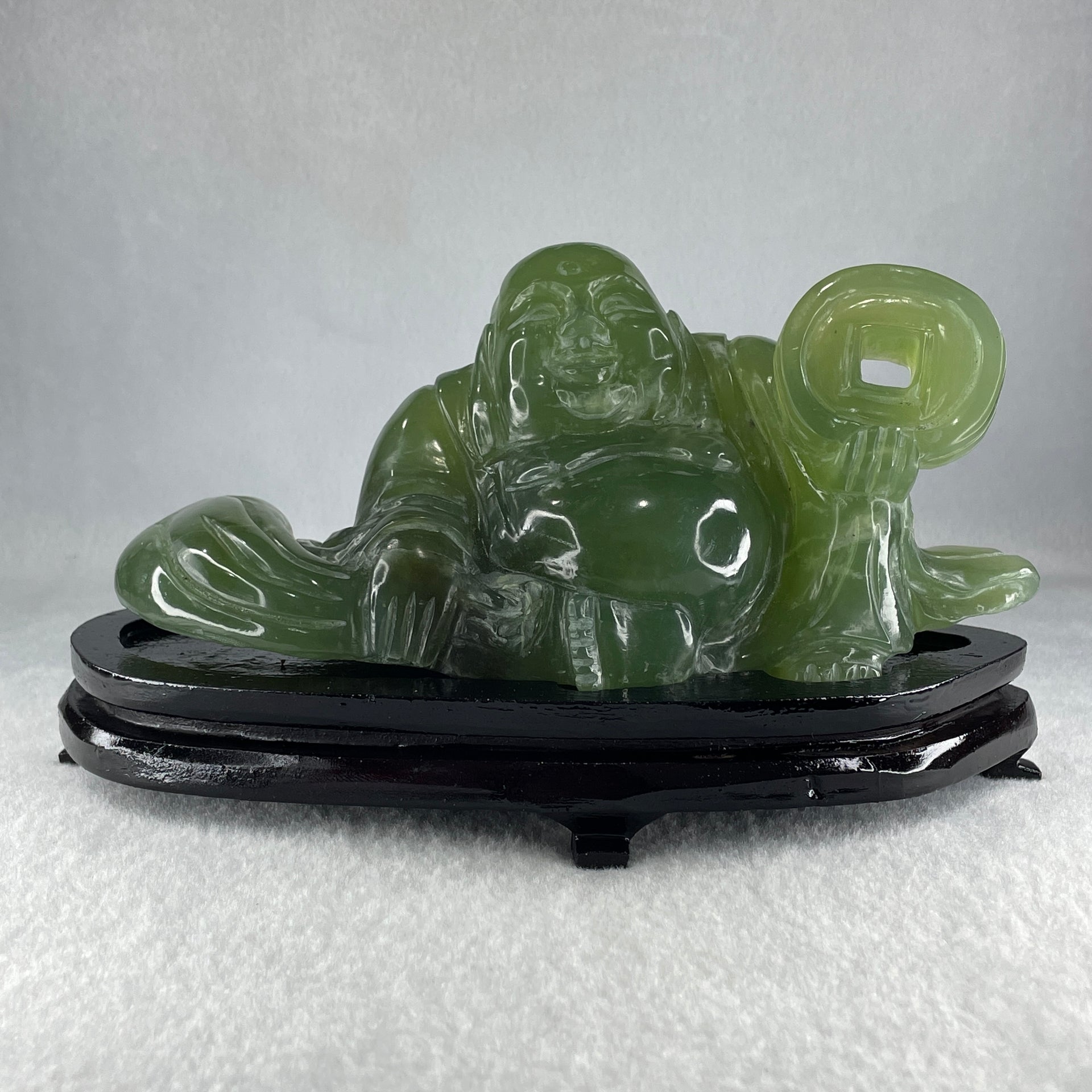 Natural Green Serpentine Siting Milo Buddha with Coin with Wooden Stand Display 1014.8g 200.0 by 100.0 by 105.0mm - Huangs Jadeite and Jewelry Pte Ltd