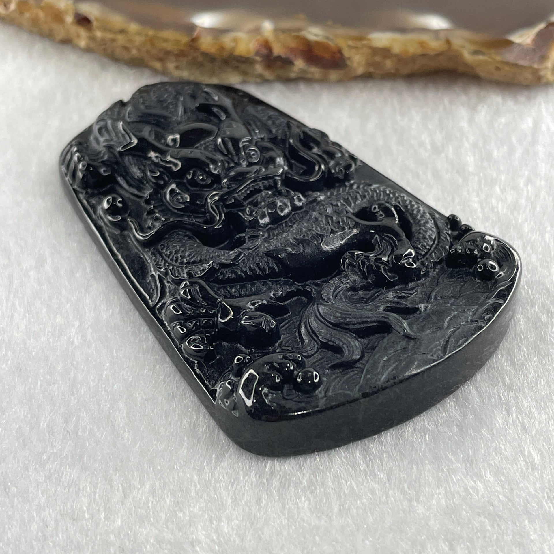Type A Opaque to Partial Translucent Black Omphacite Jadeite Dragon Pendant 32.91g 66.0 by 42.2 by 9.5mm - Huangs Jadeite and Jewelry Pte Ltd