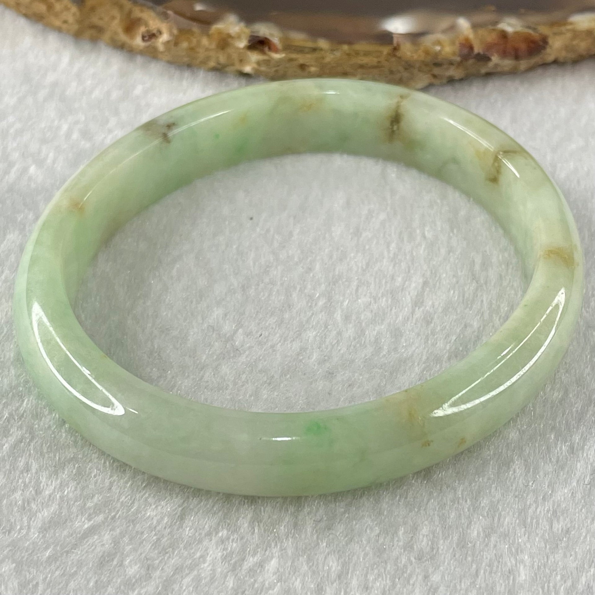 Type A Green with Brown Patches Jadeite Oval Bangle 31.51g Internal Diameter 55.6mm 10.3 by 6.6mm (External Roughs and Internal Lines) - Huangs Jadeite and Jewelry Pte Ltd