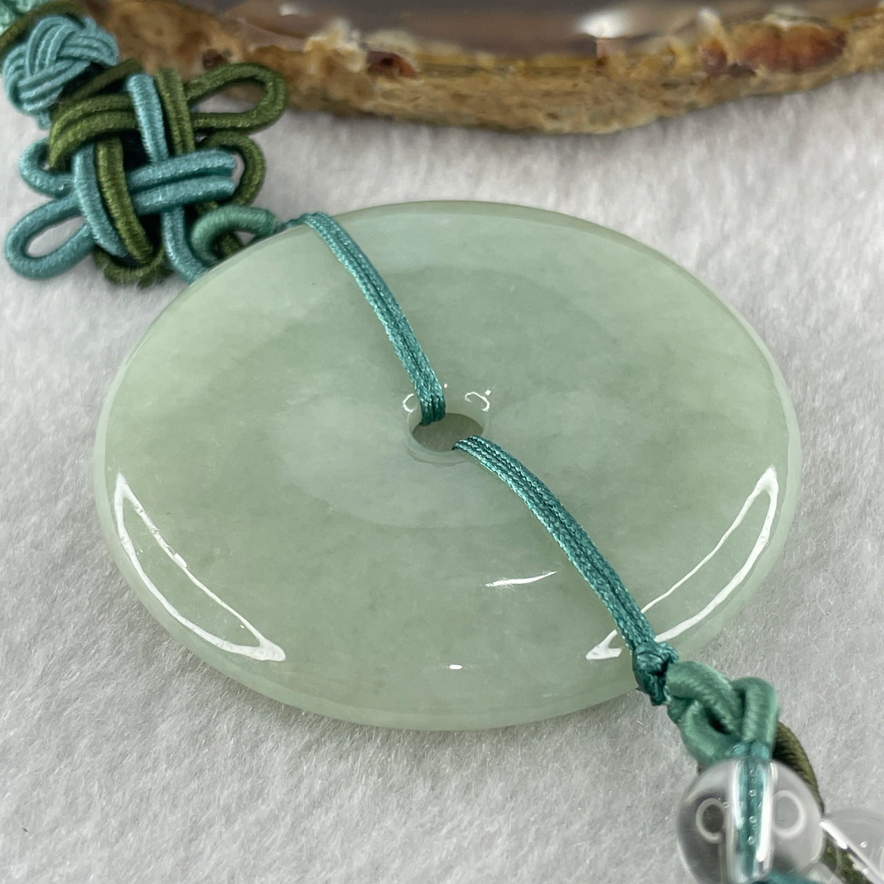Natural Type A Light Green Jadeite Ping An Kou Donut Pendant in Hanging Display String 57.40g 50.3 by 7.8mm