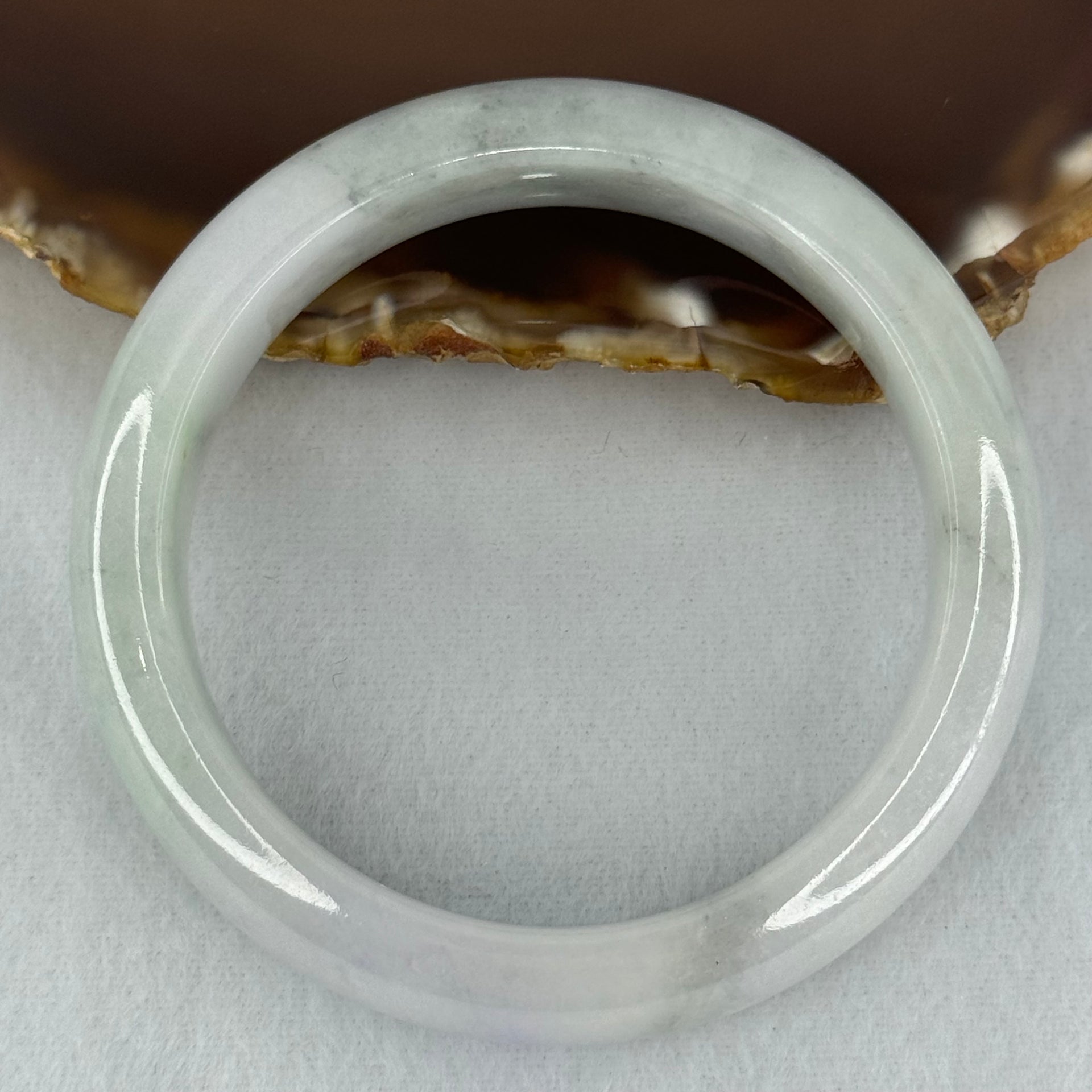 Type A Translucent Faint Blueish Green with Patches of Light Grey and Faint Lavender Jadeite Bangle Internal Diameter 56.95mm 344.09cts 69.22g 14.6 by 8.9mm With NGI Cert No 32886054 (Very Slight Internal Line) - Huangs Jadeite and Jewelry Pte Ltd