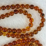 Natural Cognac Amber Ruyi Pendent 37.7 by 27.0 by 12.2mm in Amber Beads Necklace 6.3mm 105 Beads Total 19.80g - Huangs Jadeite and Jewelry Pte Ltd