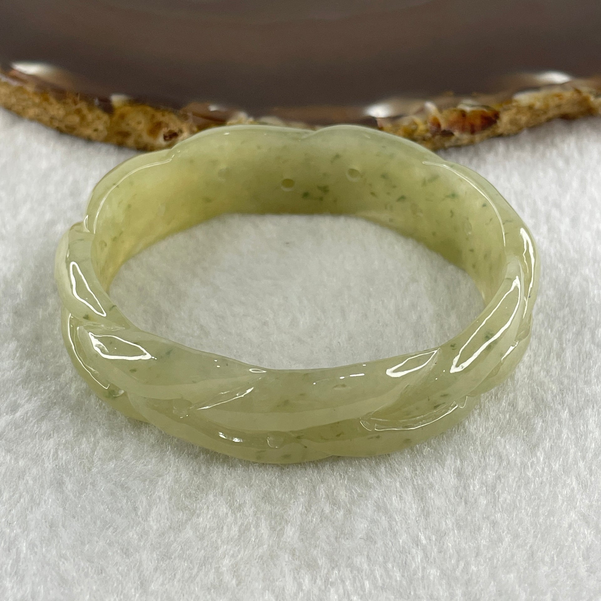 Type A Natural Yellowish Green Jadeite Oval Carved Bangle 41.73g Inner Diameter 54.2mm 16.5 by 7.1mm (Very Very Slight Internal Lines) - Huangs Jadeite and Jewelry Pte Ltd