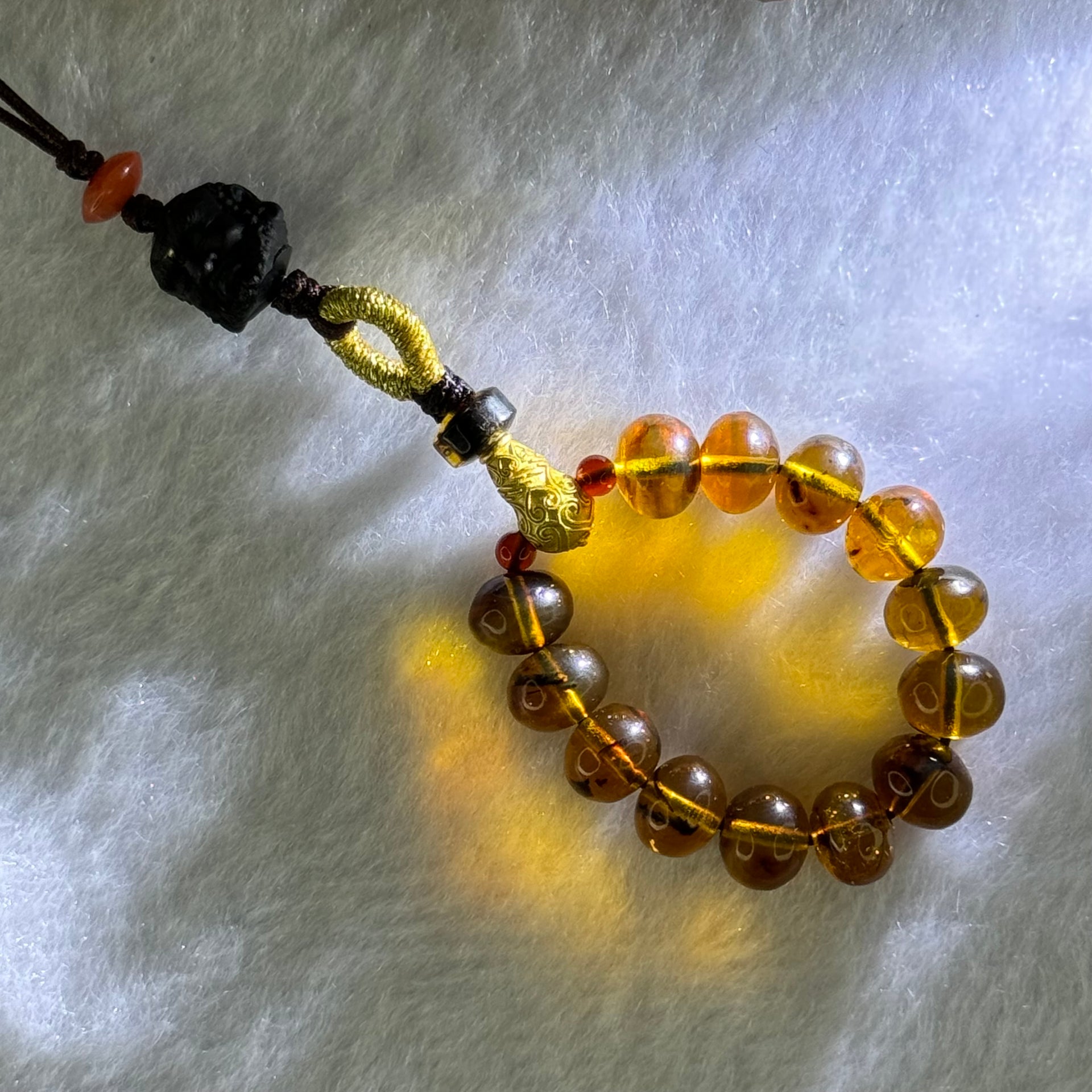 Natural Cognac Amber with Damo Head Handphone Strap 4.30g 7.6mm 13 Beads - Huangs Jadeite and Jewelry Pte Ltd