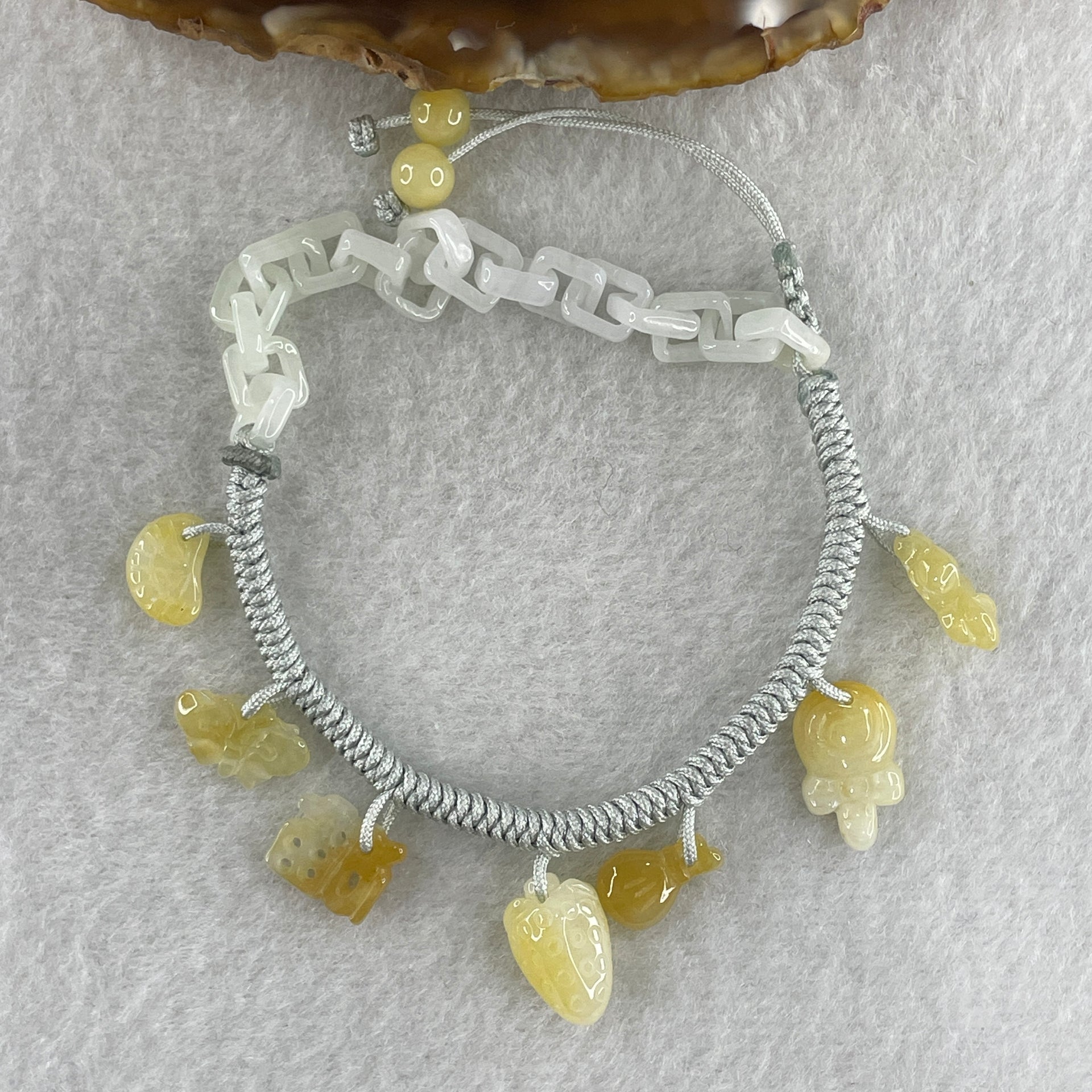 Natural Type A Yellowish Jadeite Money Bag Hulu Fu Butterfly in String Bracelet 8.79g 16-20cm 12.7 by 8.8 by 6.9mm - Huangs Jadeite and Jewelry Pte Ltd